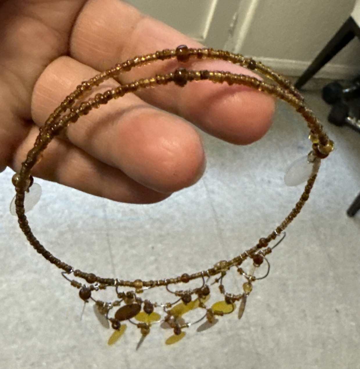 gold-tone seed bead choker necklace with yellow and brown disc pendants.