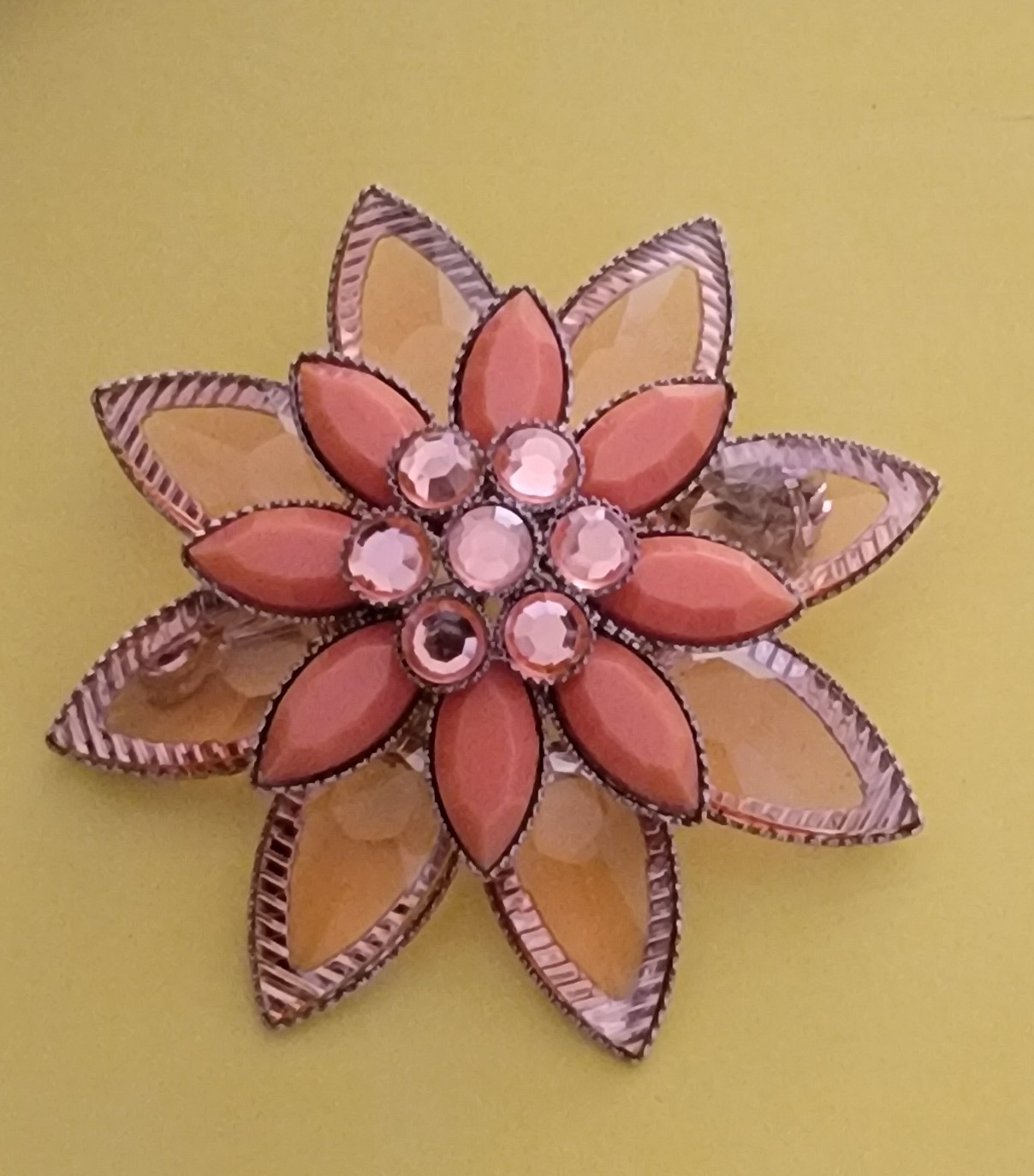 Coral-colored and translucent tiered flower brooch pin