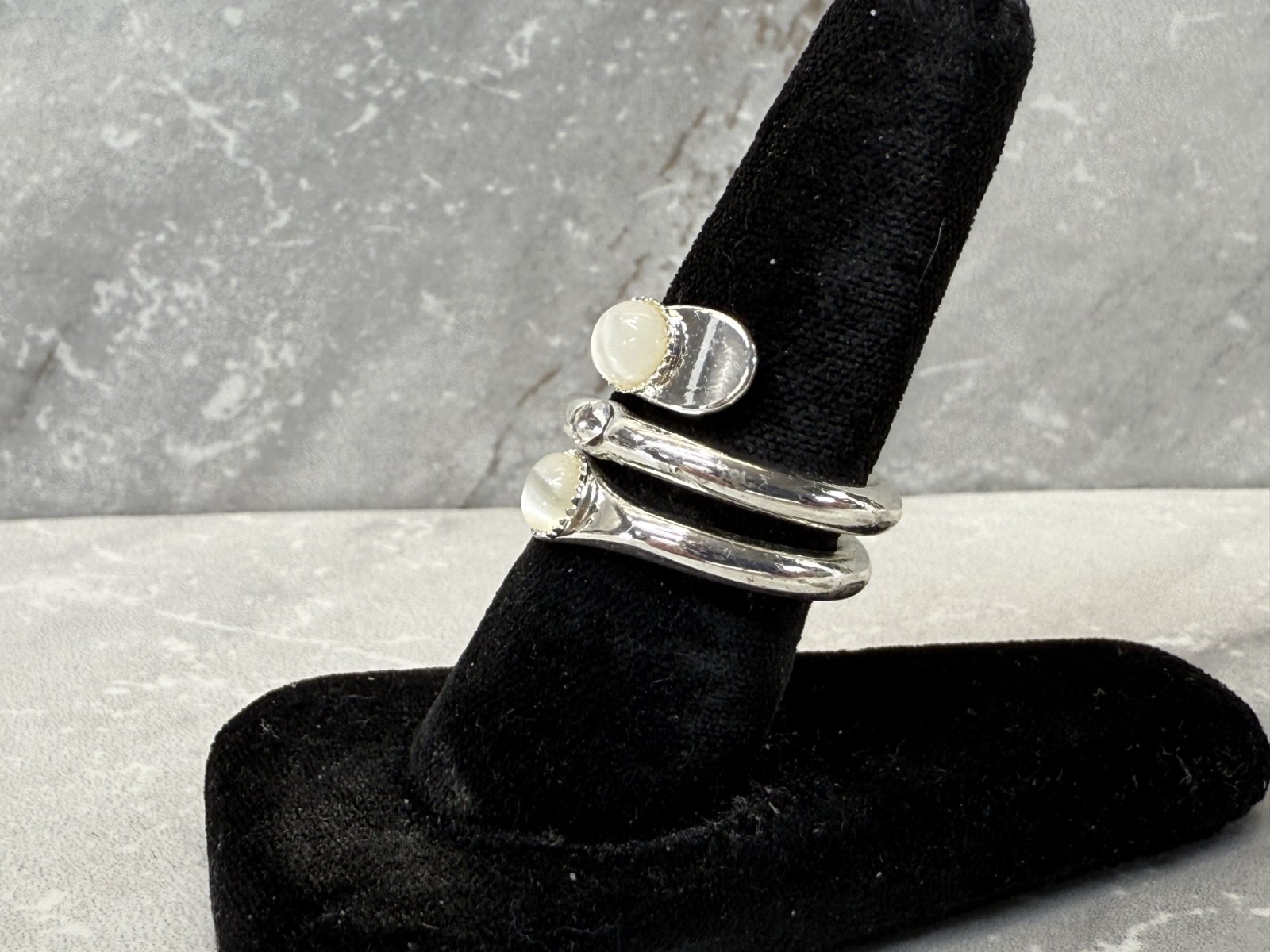 Silver tone wrap with white cat eye and righnstone ring size 6