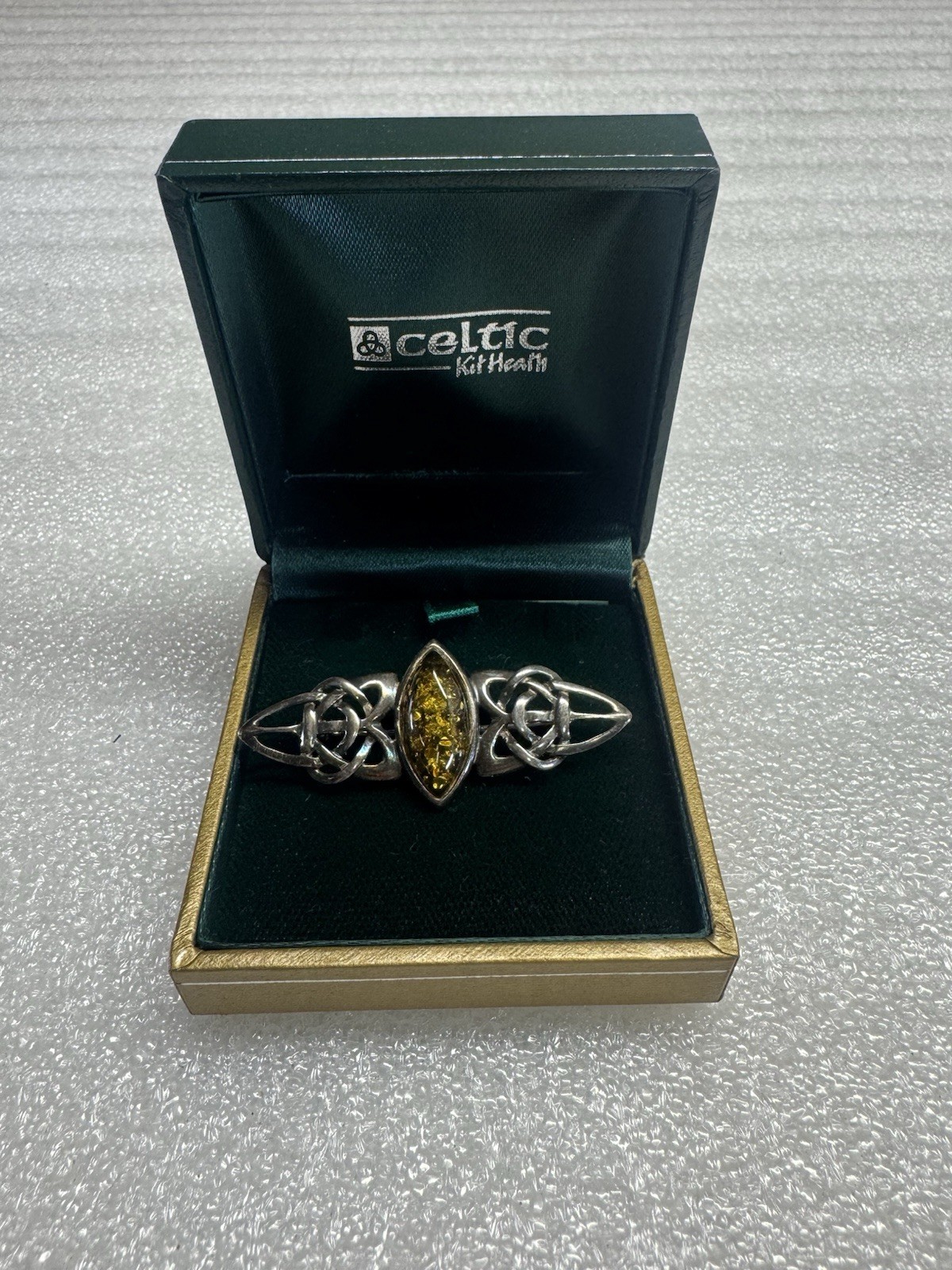 Kit Heath sterling silver brooch features a marquise-cut amber stone