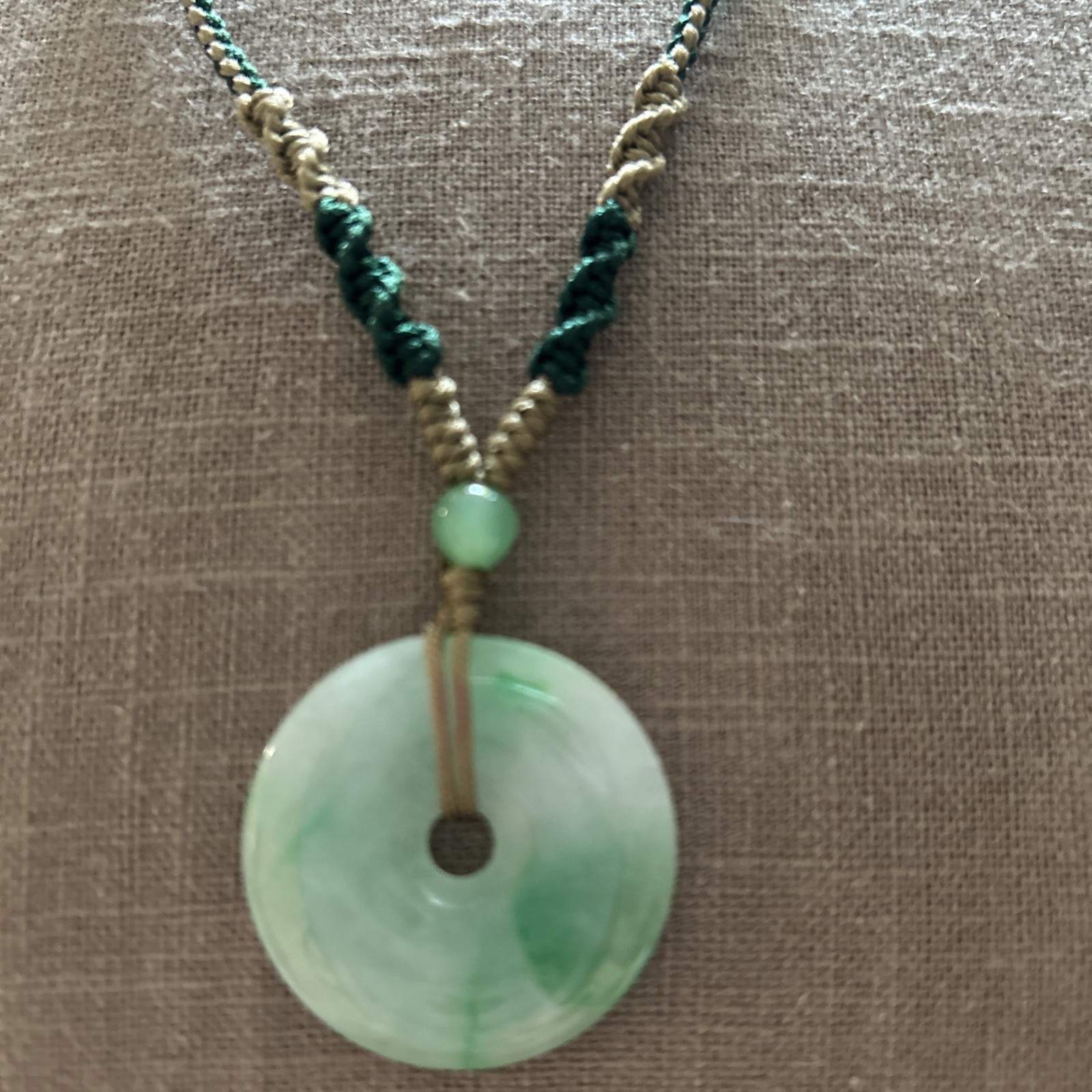Vintage Green Jade Pendant 1-1/8” on a braided tan and green cord w/3 jade beads