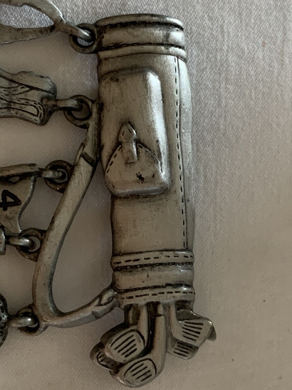 Jonette Jewelry (JJ) golf-themed brooch made of pewter or a similar alloy