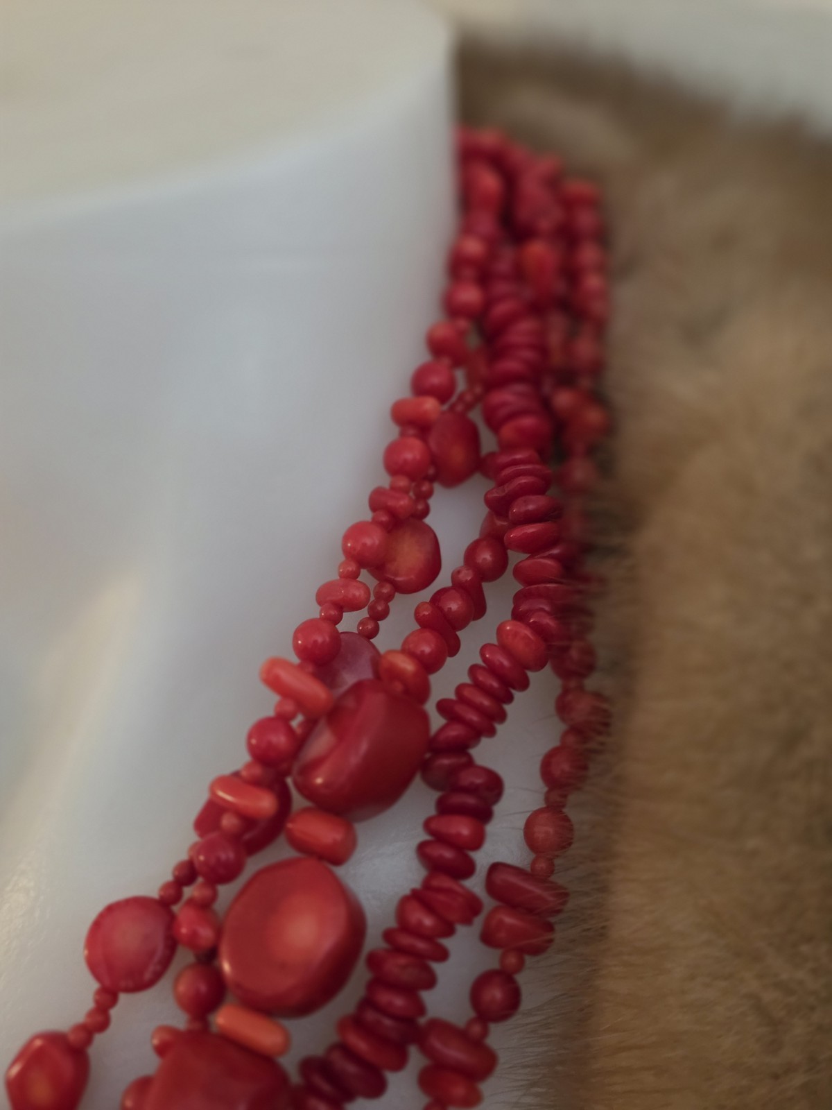 multi-strand red coral bead necklace Different shapes and sizes.