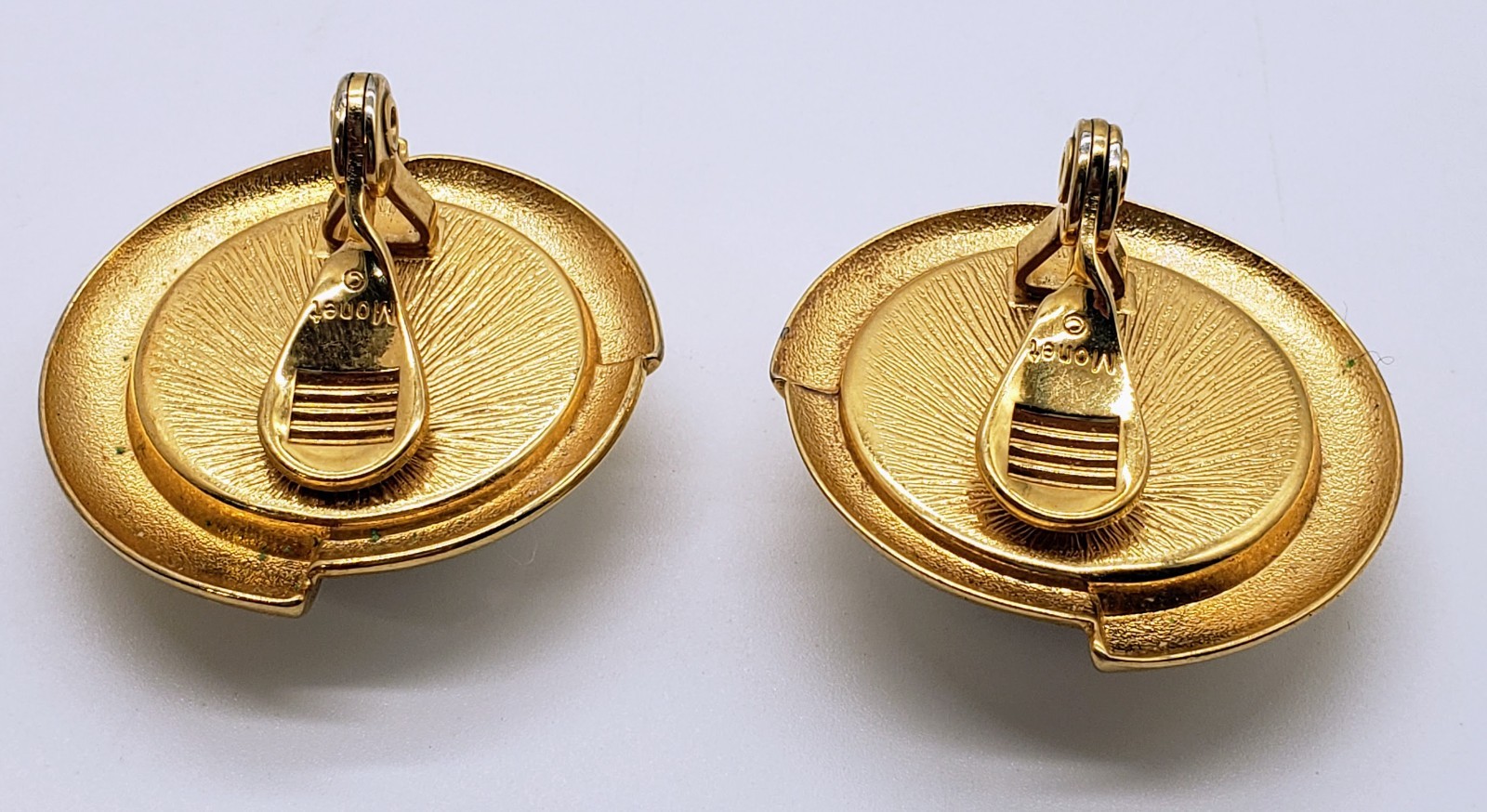 Vintage Monet Clip-on Earings. White on Gold-tone metal. About 1″ diameter