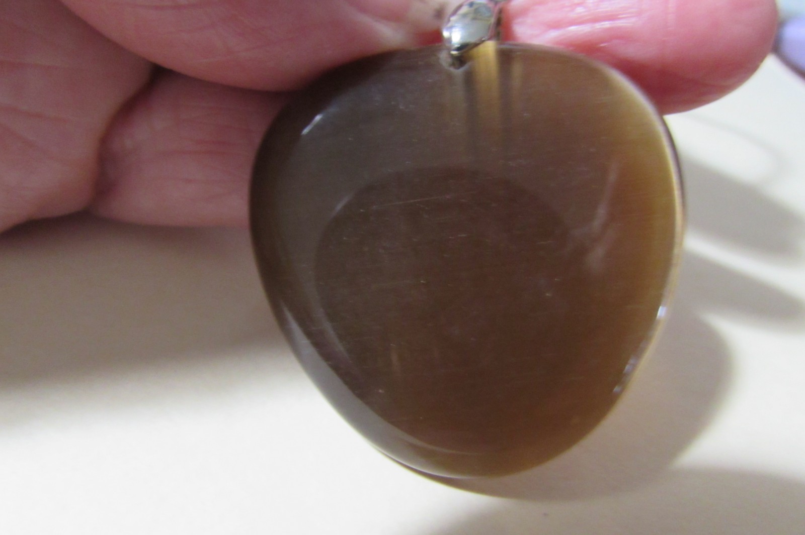 18″ long black stretchy cord necklace with almost 2″ brown smooth stone/rock fob