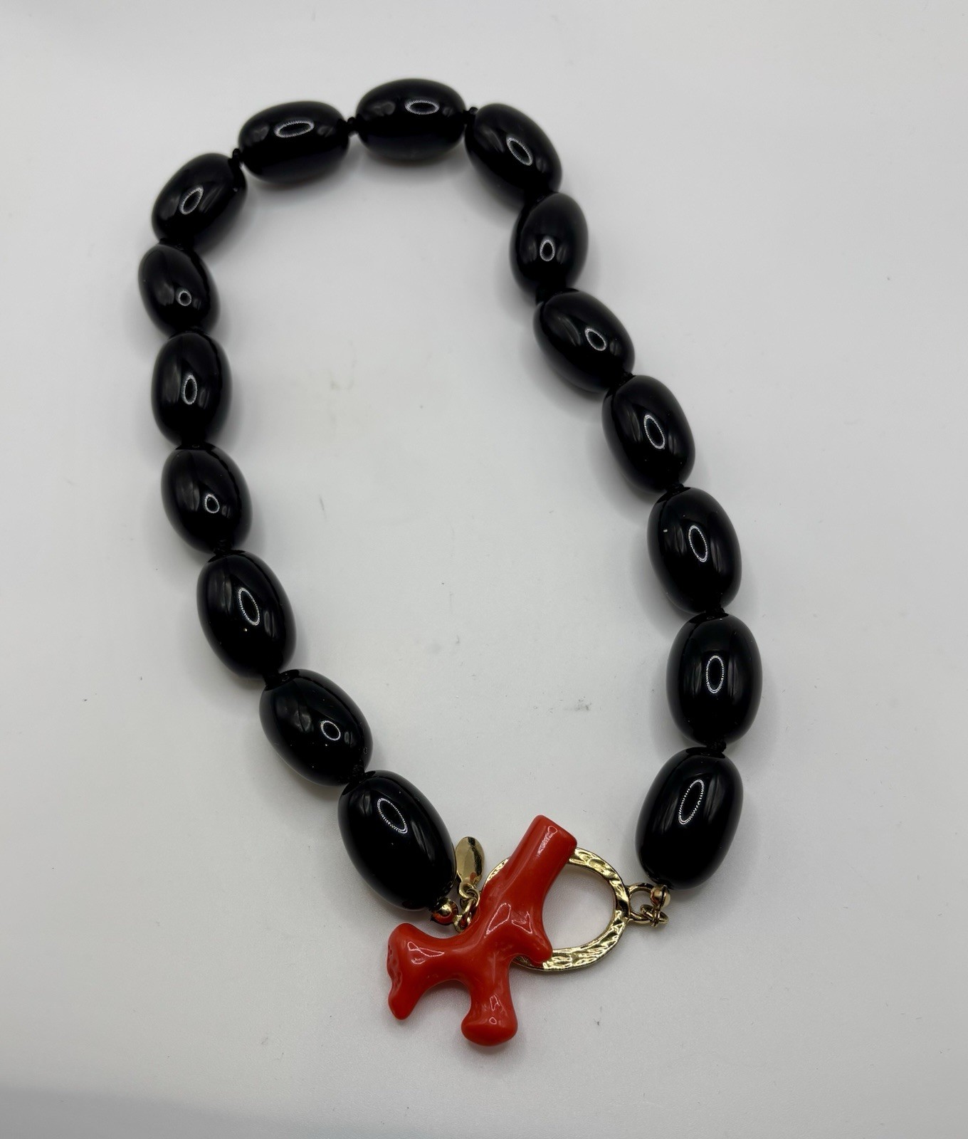 Kenneth Jay Lane ‘Andros’ necklace black lucite beads faux coral toggle closure.