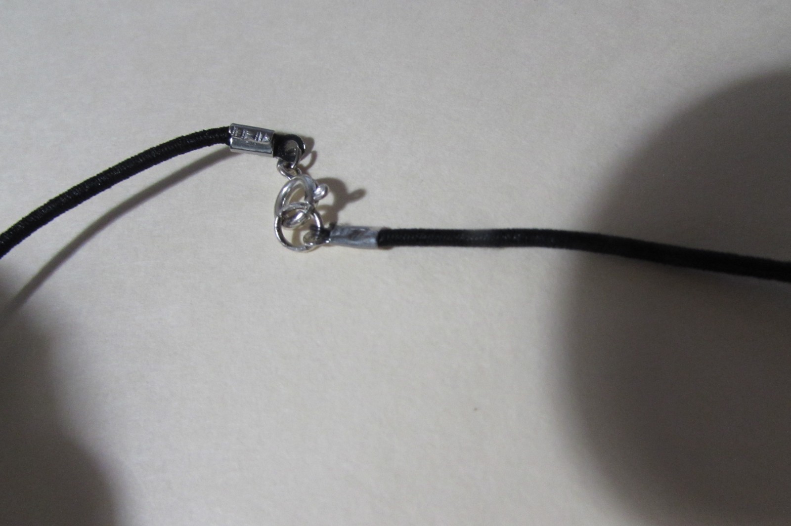 18″ long black stretchy cord necklace with almost 2″ brown smooth stone/rock fob