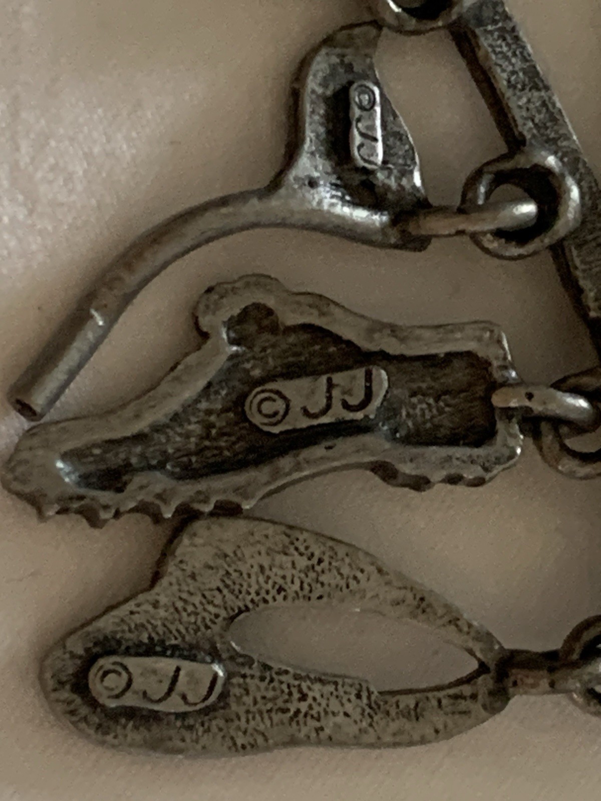 Jonette Jewelry (JJ) golf-themed brooch made of pewter or a similar alloy