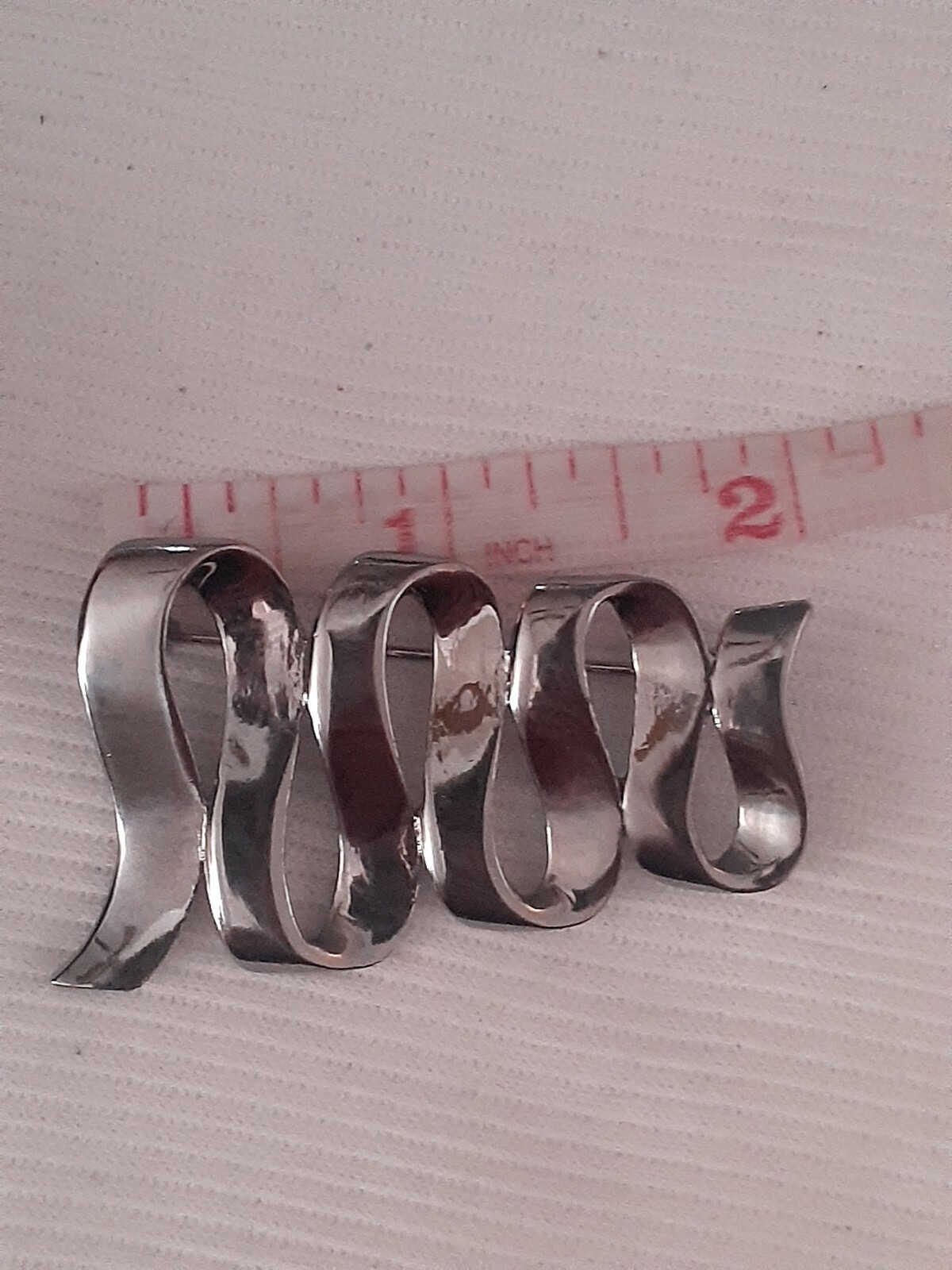 Vintage M Jent polished silvertone Swirl ribbon design Brooch/pin