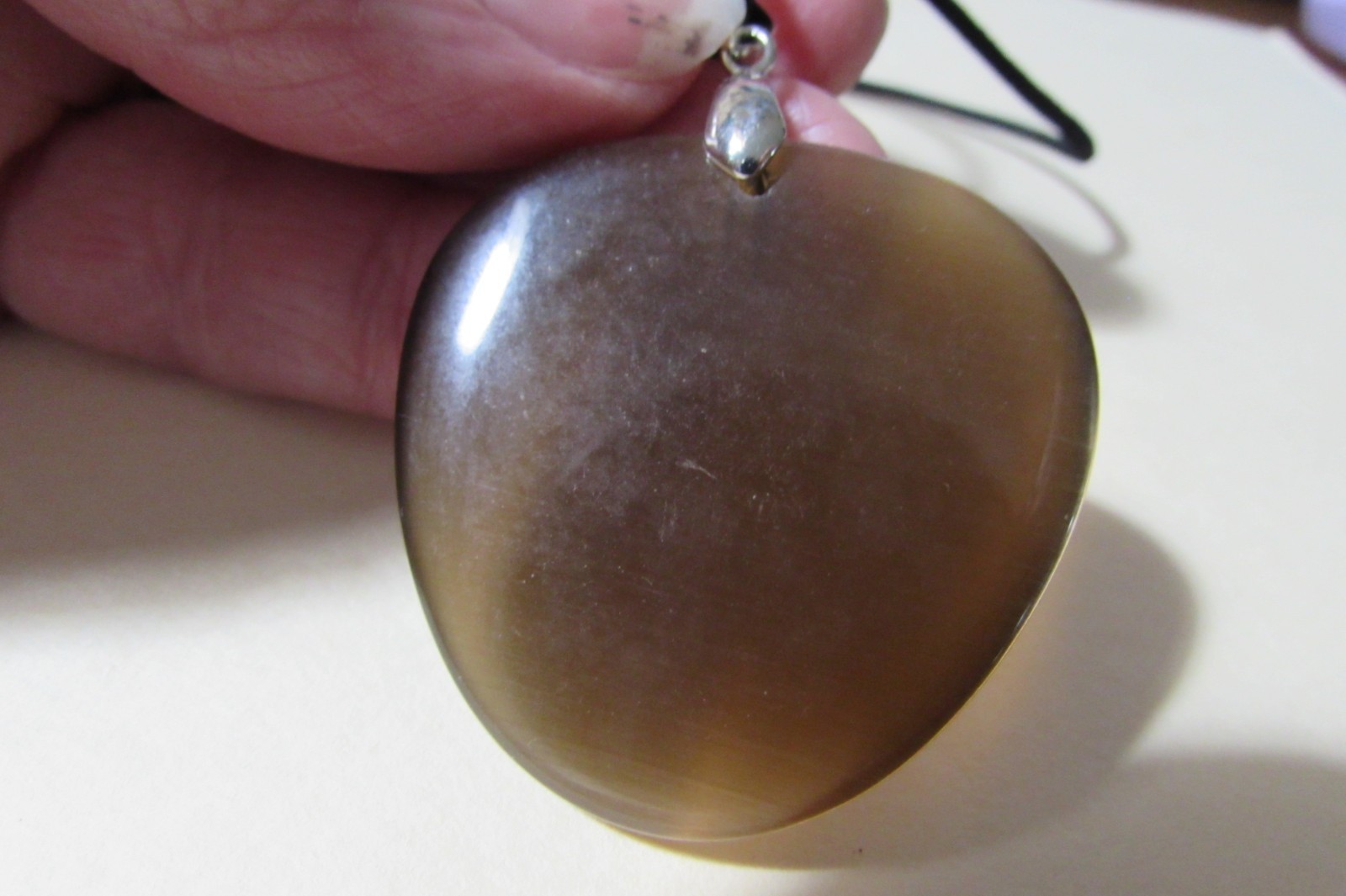 18″ long black stretchy cord necklace with almost 2″ brown smooth stone/rock fob