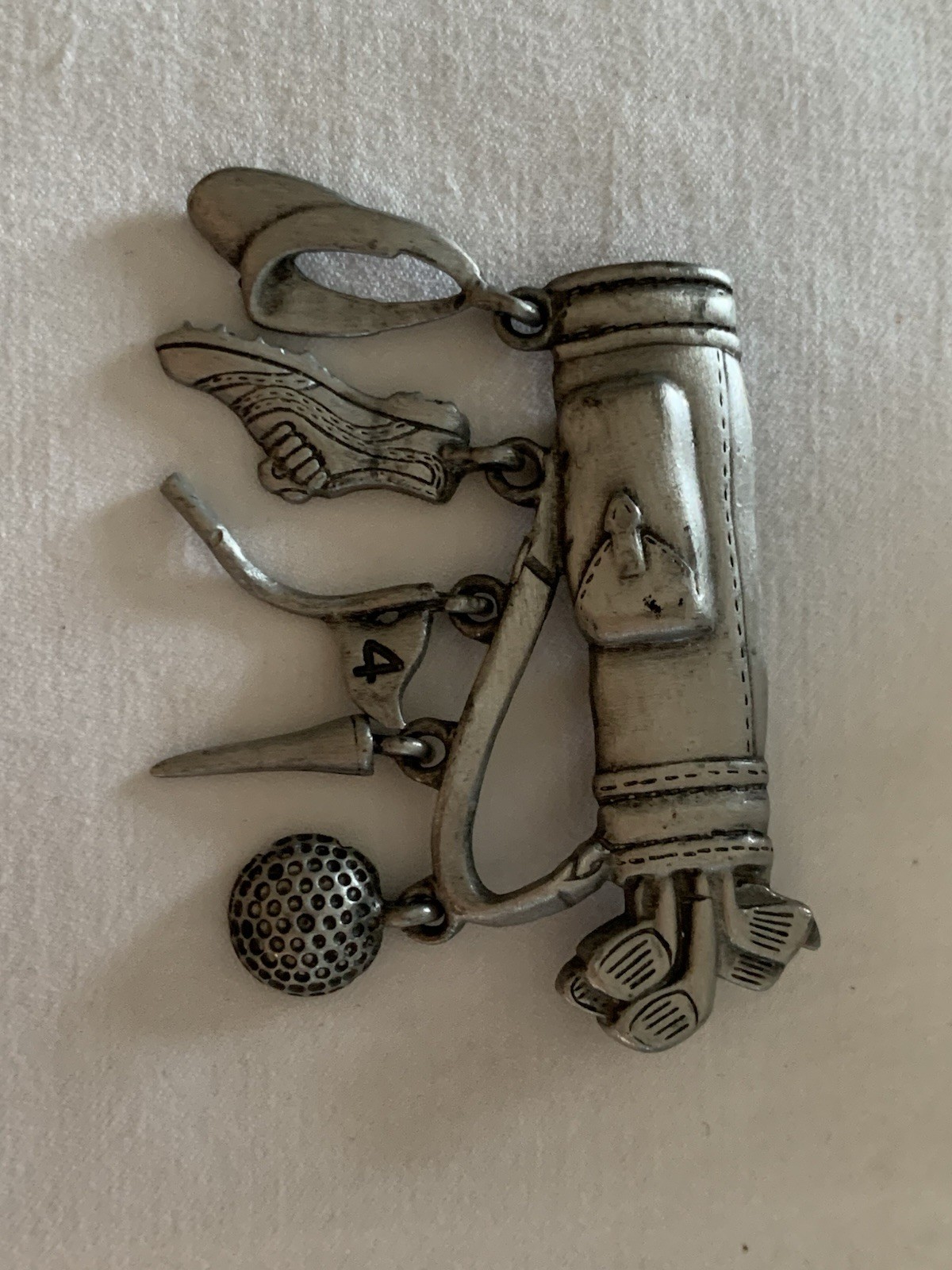 Jonette Jewelry (JJ) golf-themed brooch made of pewter or a similar alloy