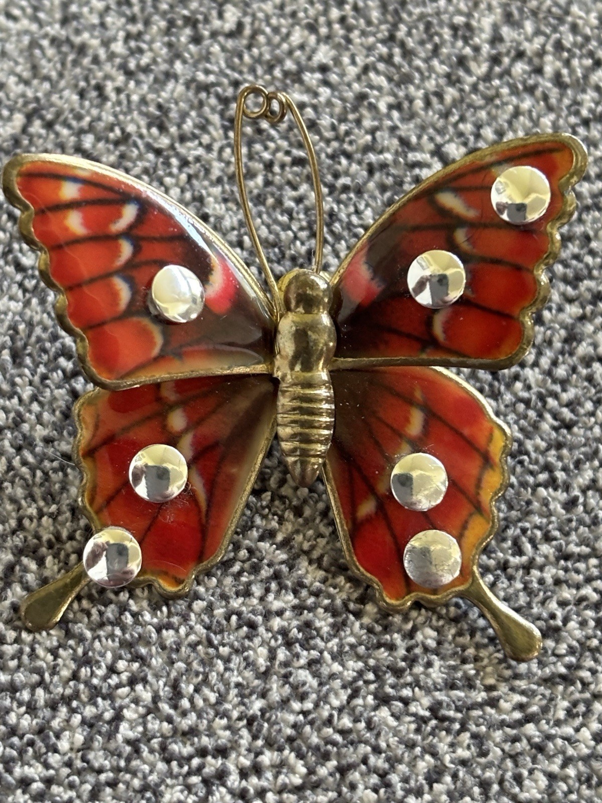 Butterfly Brooch or Pendant of Red Orange and Cream Resin on Gold Tone Setting.
