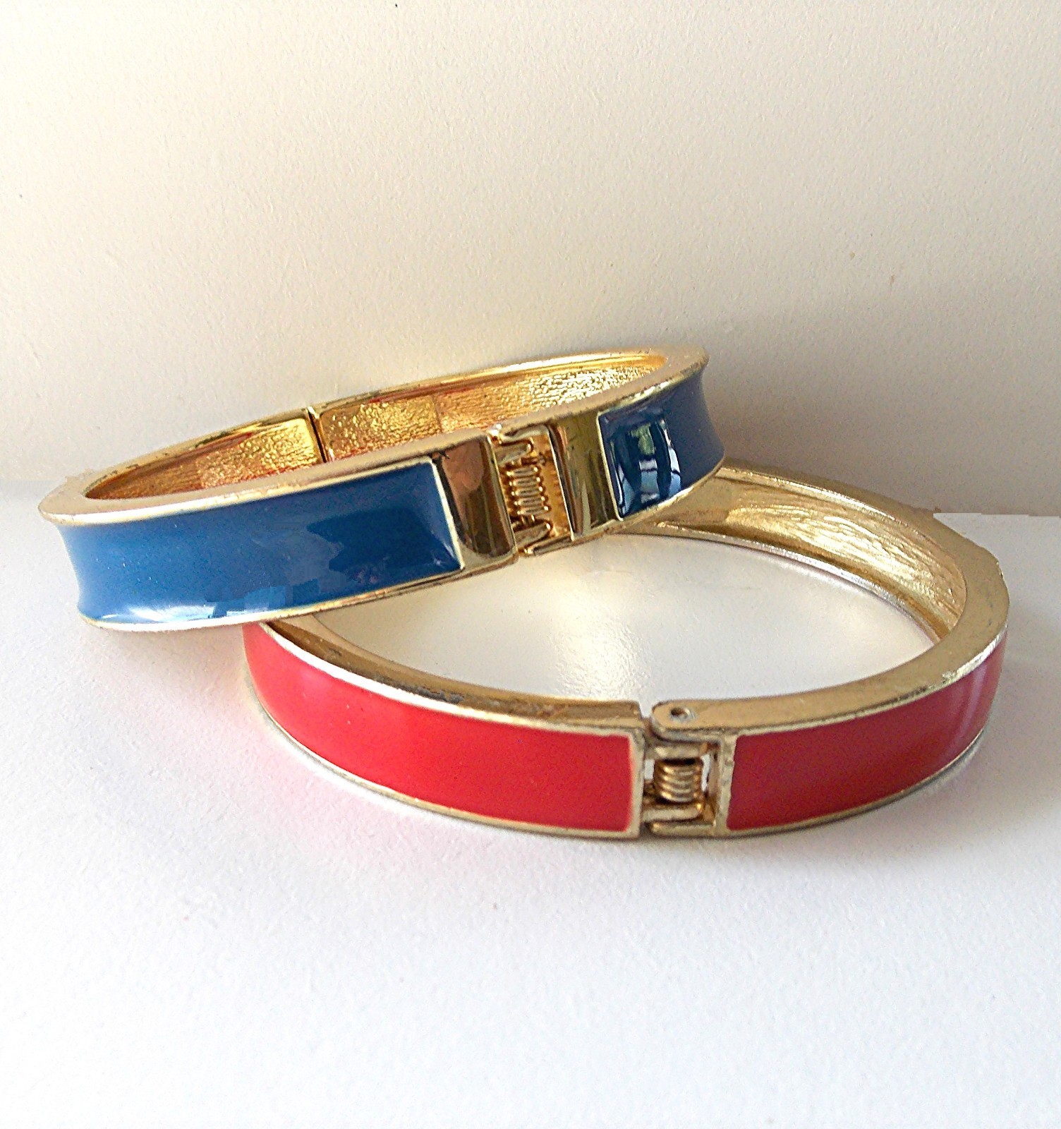 TWO DIFFERENT VINTAGE ENAMELED GOLD TONE HINGED CLAMPER BRACELETS-1 RED & 1 BLUE