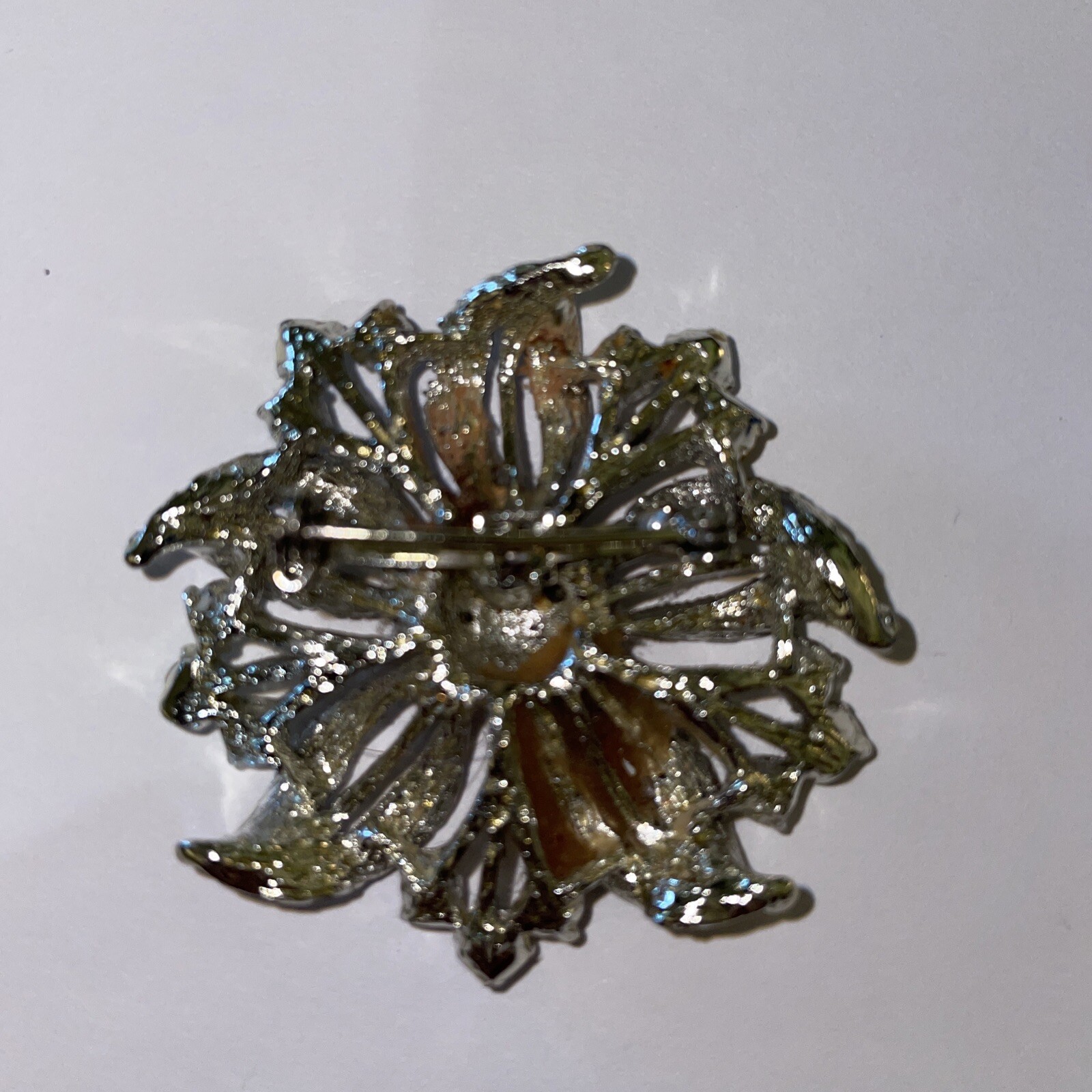 Silver-tone flower brooch w/ pale blue stones (center stone missing)–preowned