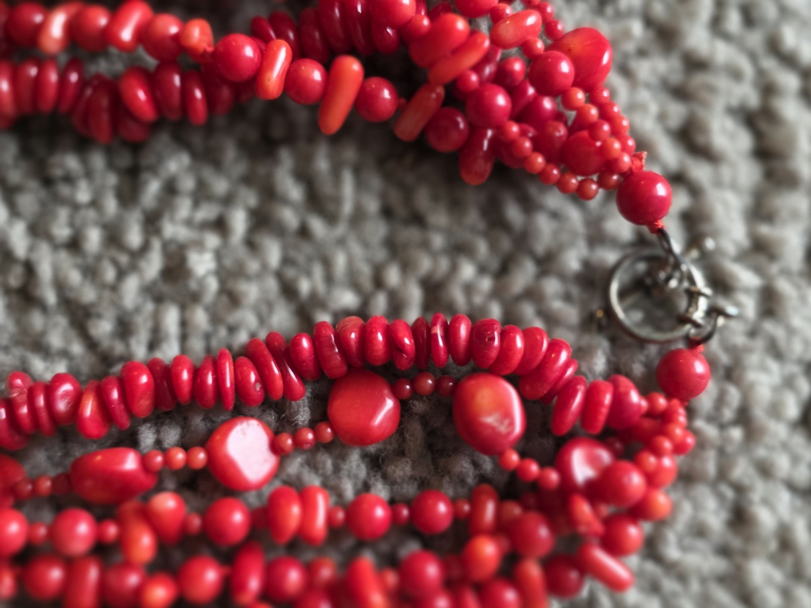 multi-strand red coral bead necklace Different shapes and sizes.