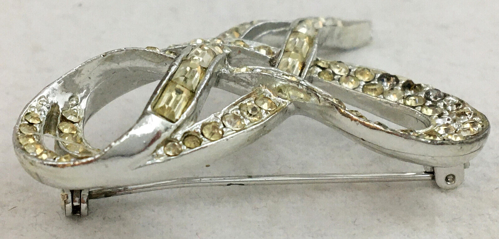 SilverTone Swirl Ribbon Brooch Pin With Clear Round with Bagette Crystals TG