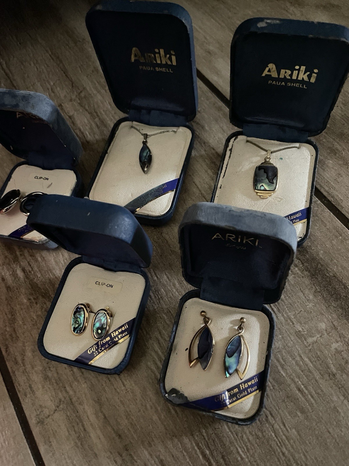 Vintage Ariki New Zealand paua shell jewelry sets in their original blue boxes.
