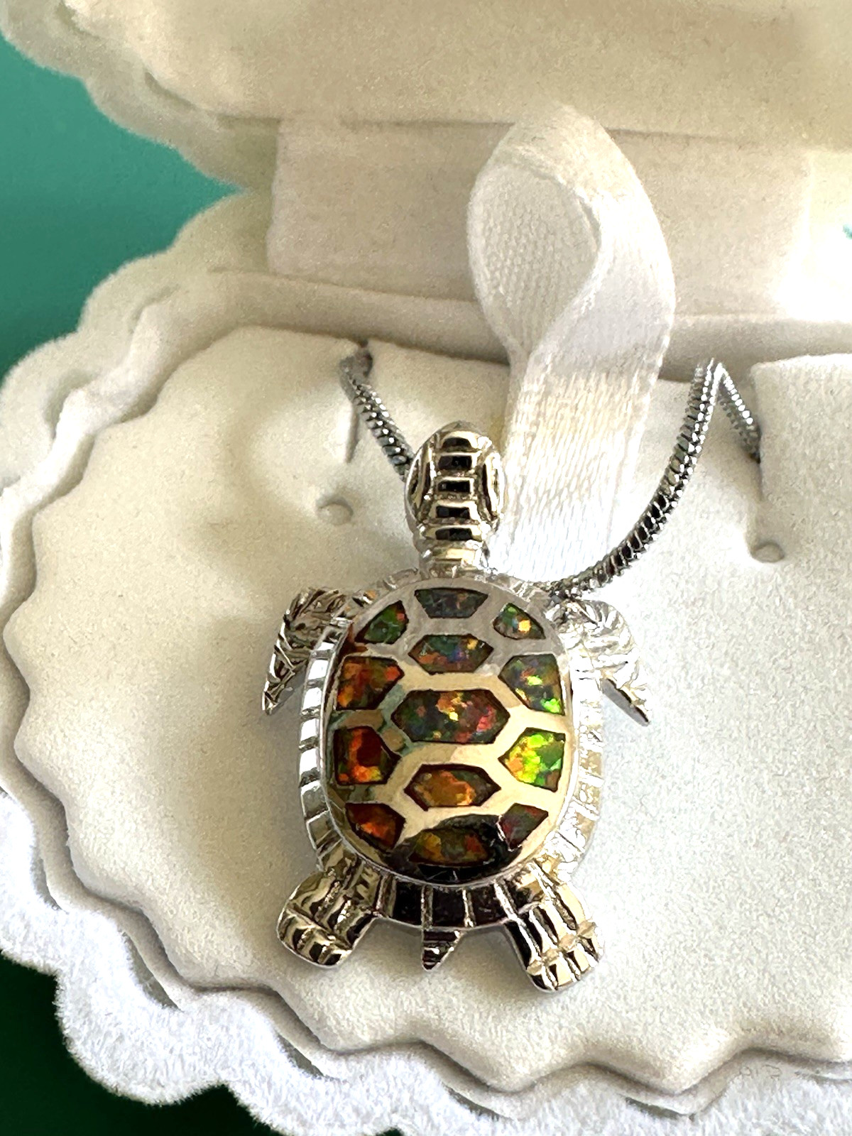 Sea turtle pendant featuring orange fire opals. Sterling silver chain. Shell box