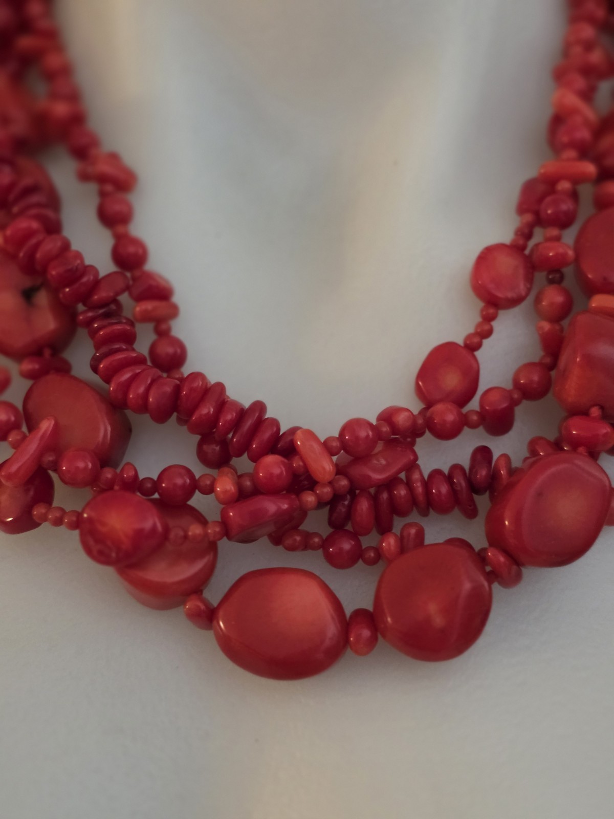 multi-strand red coral bead necklace Different shapes and sizes.