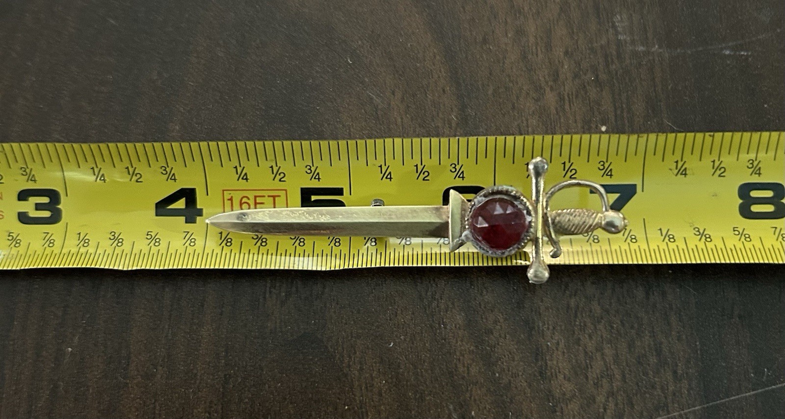 Vintage Brass Tone Sword Pin Red Round Bezel Stone Signed Broadcast