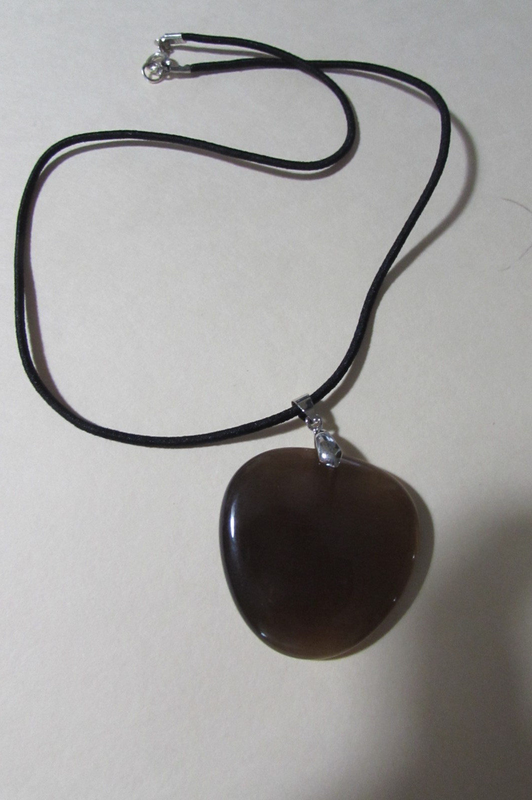 18″ long black stretchy cord necklace with almost 2″ brown smooth stone/rock fob