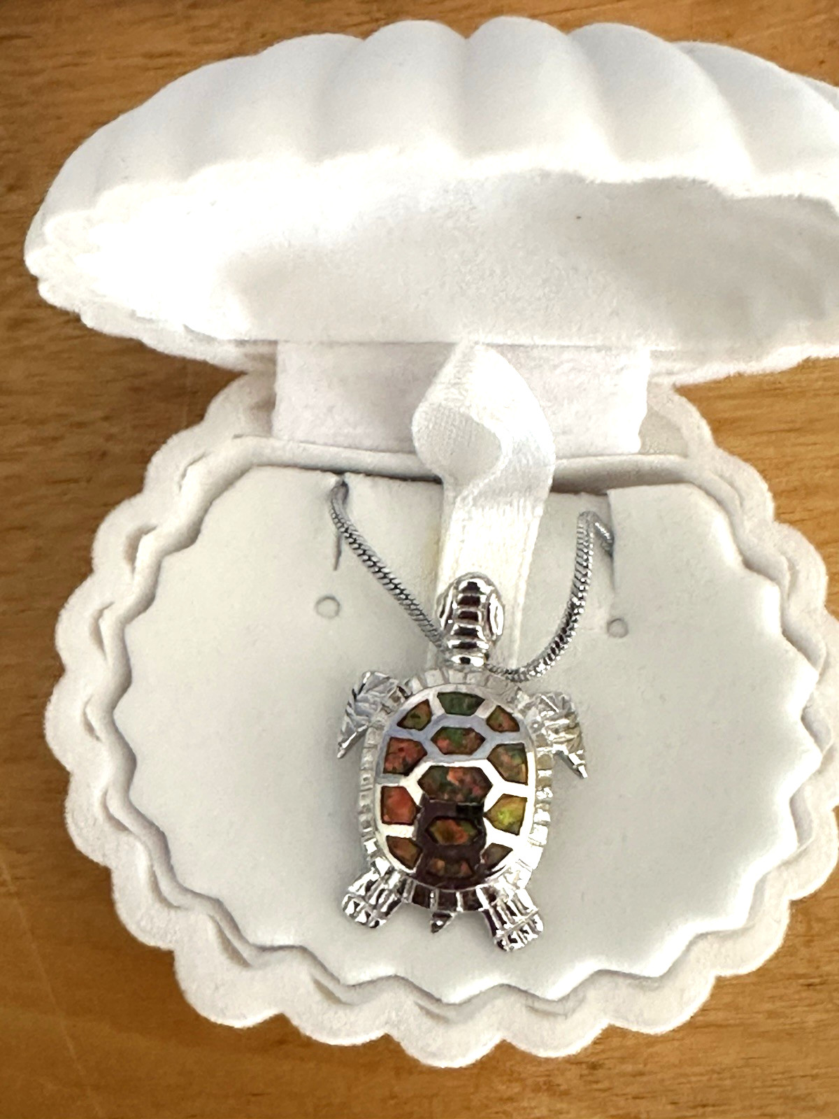 Sea turtle pendant featuring orange fire opals. Sterling silver chain. Shell box