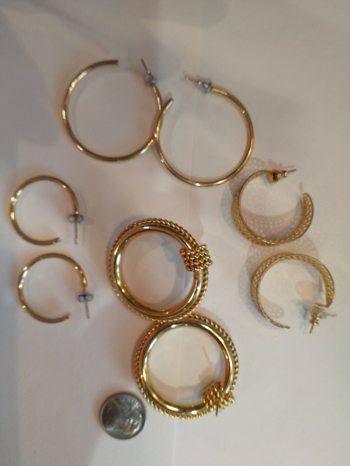 Four pair gold hoops different sizes and shapes pierced