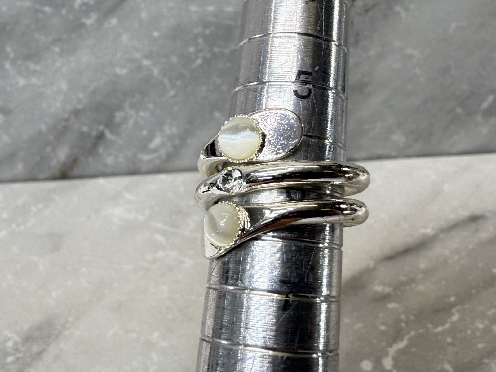 Silver tone wrap with white cat eye and righnstone ring size 6