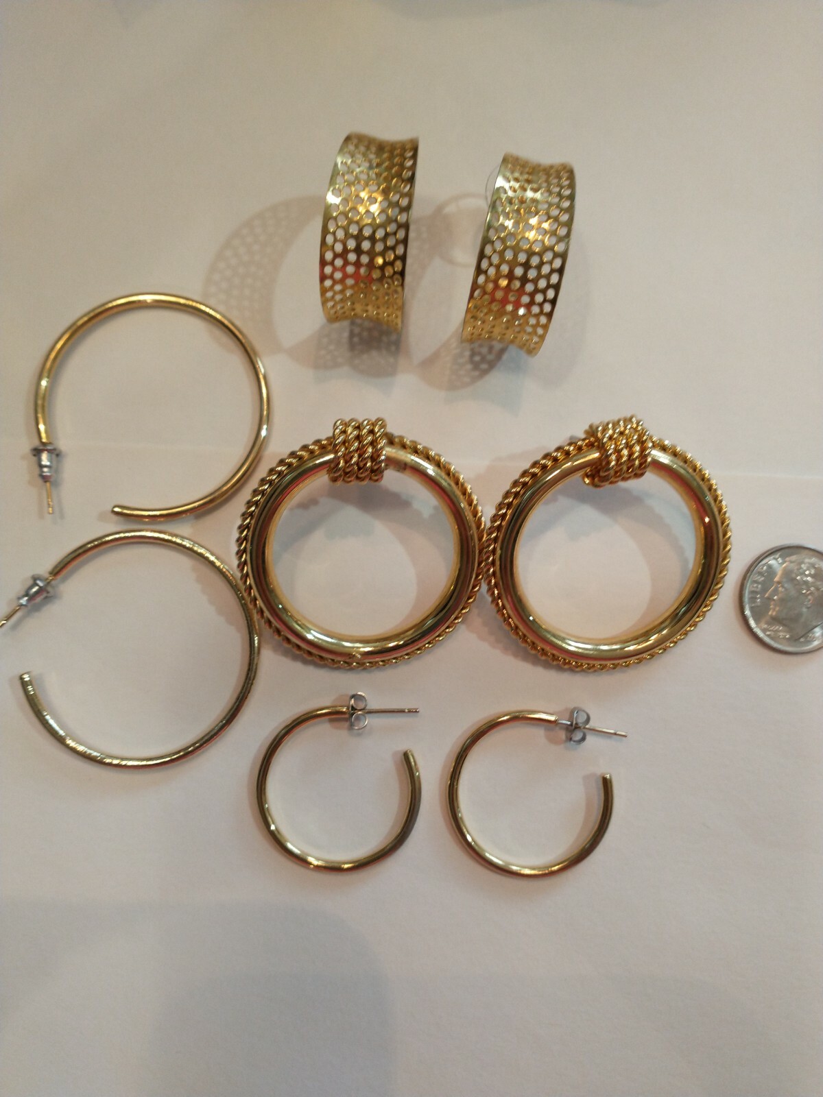 Four pair gold hoops different sizes and shapes pierced