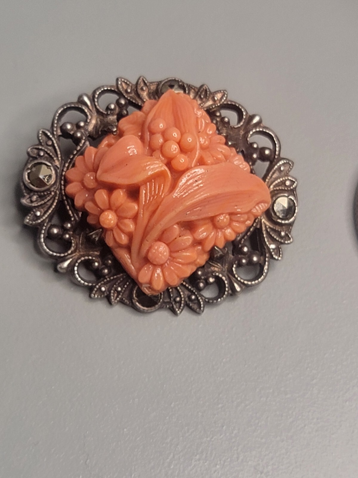 Vintage sterling marcasite coral colored molded peking glass brooch
