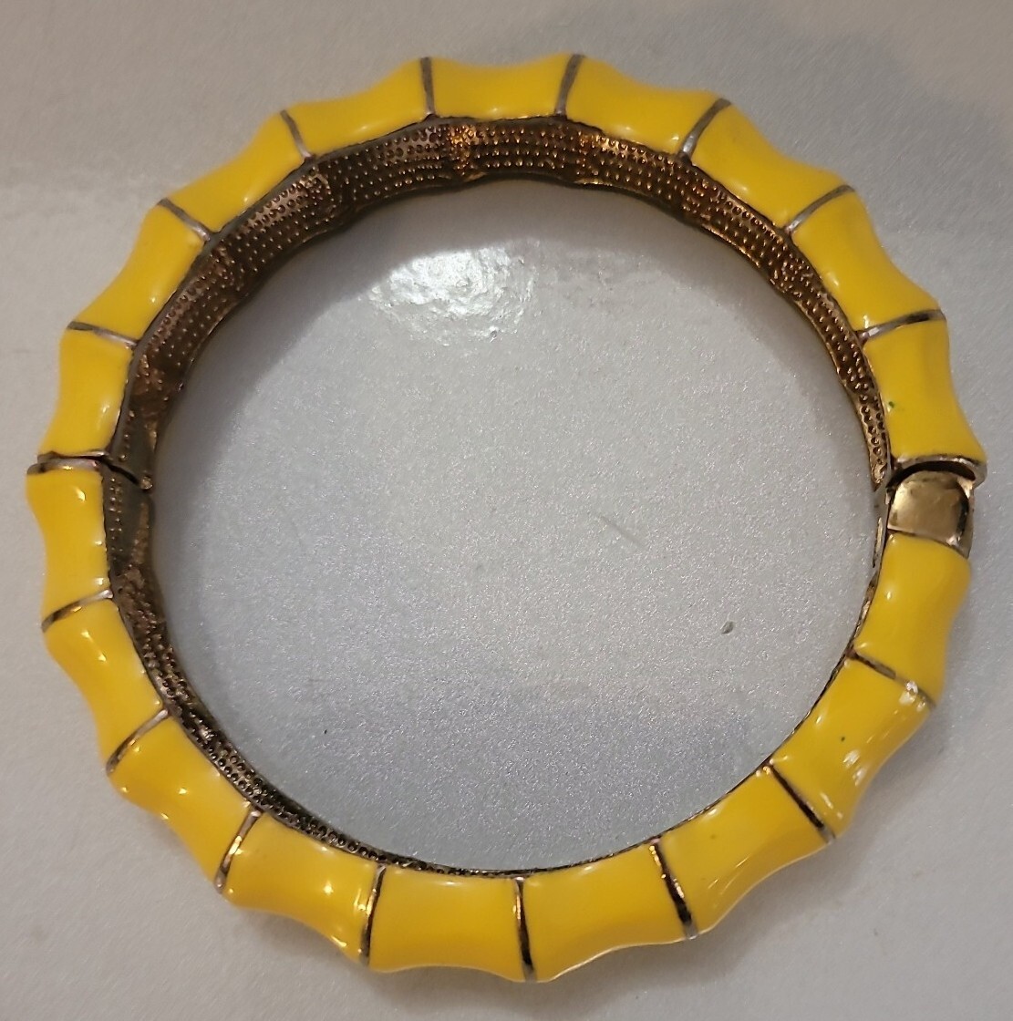 Hinged clamper Yellow bracelet on shapely goldton jewelry