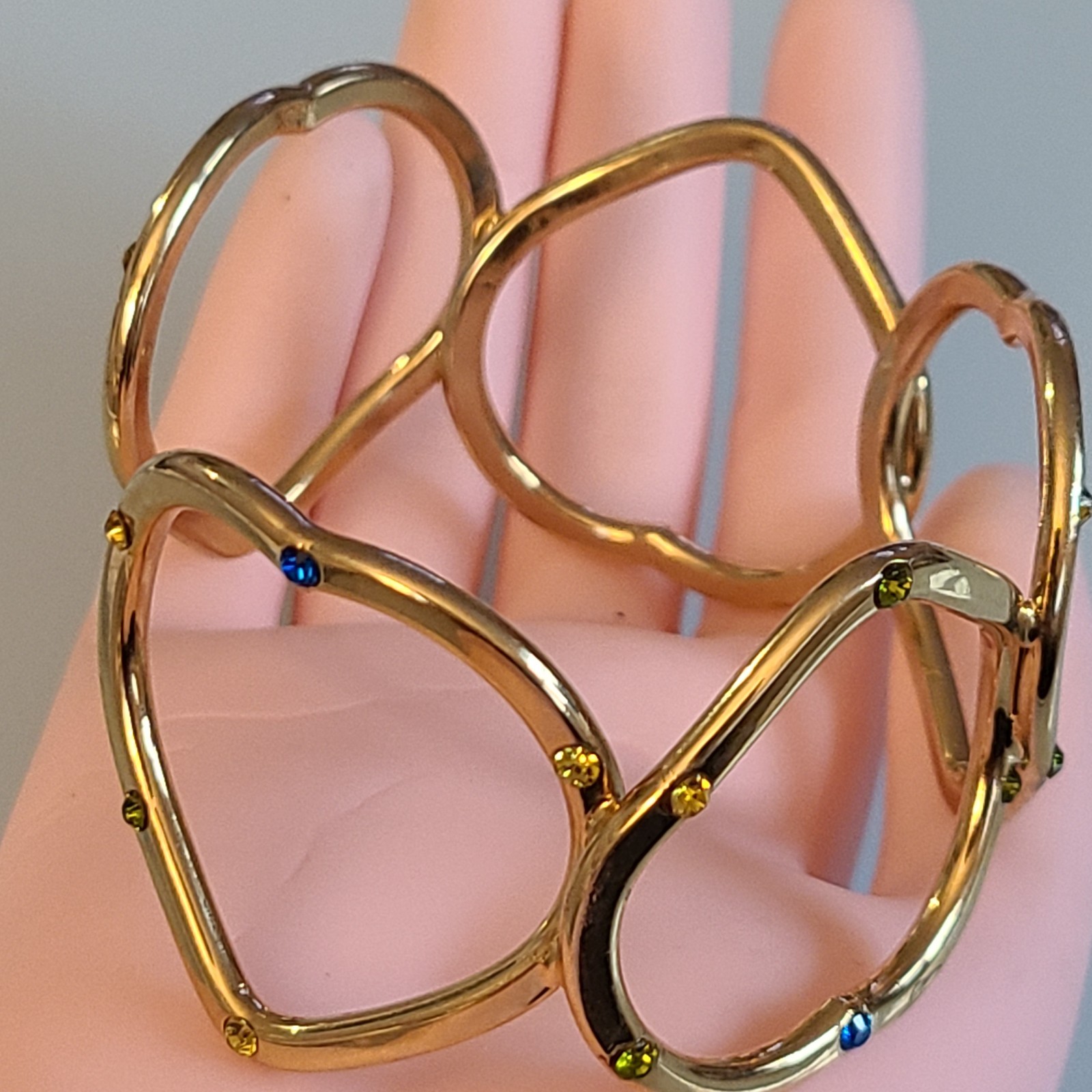 Gold-Tone Open Heart Hinged Cuff Bracelet with Multi-Color Rhinestones.