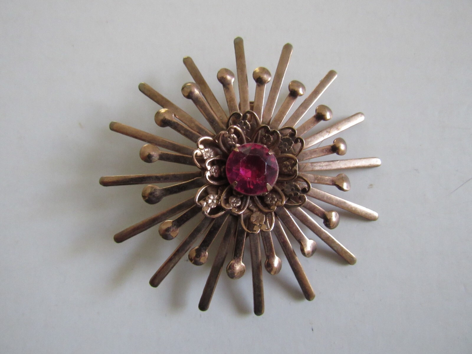 Unbranded Rose Gold Color Starburst Brooch / Pin w Pink Center Stone Vintage