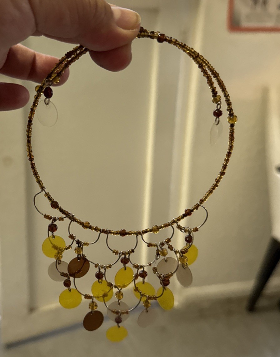 gold-tone seed bead choker necklace with yellow and brown disc pendants.
