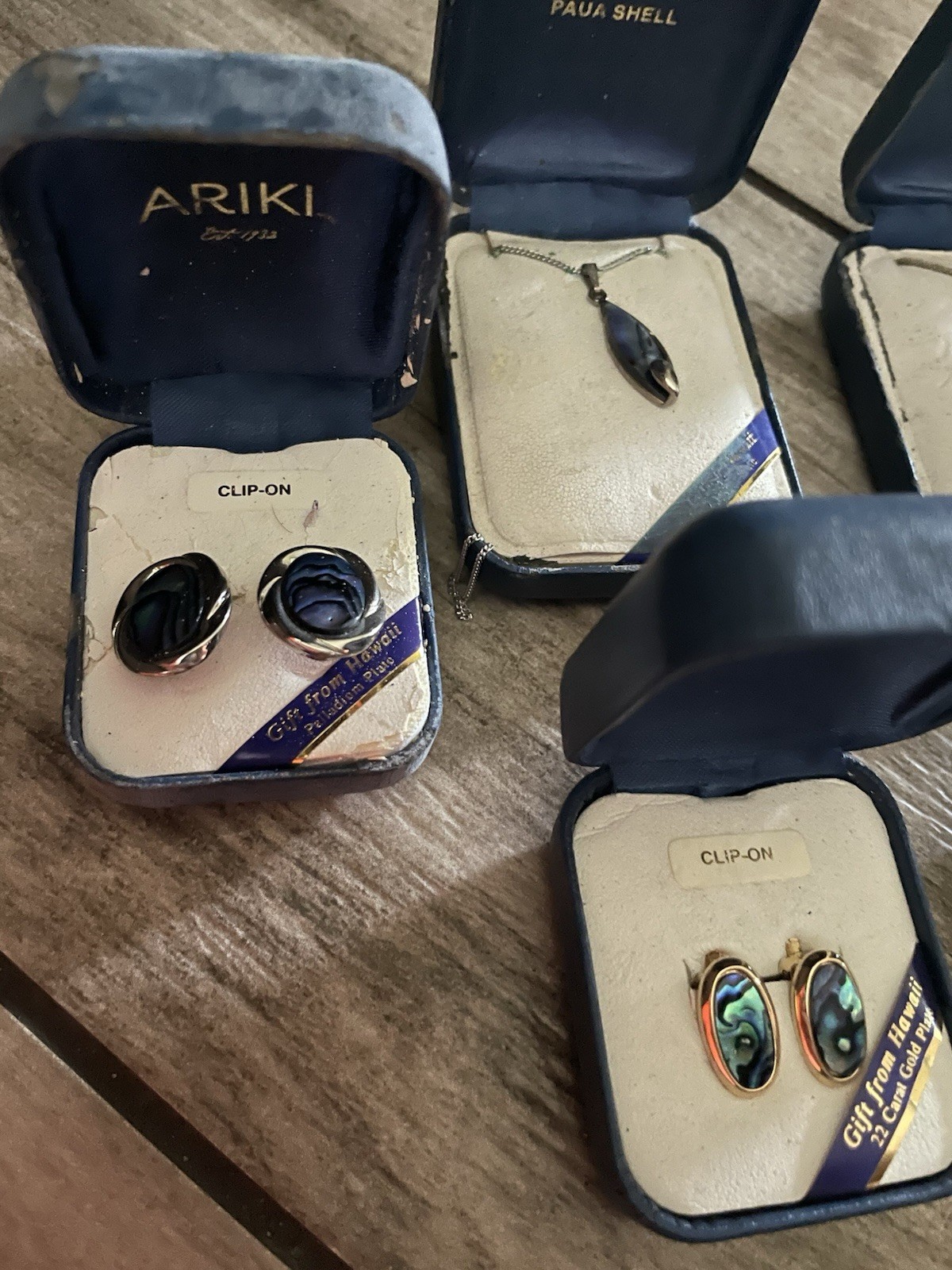 Vintage Ariki New Zealand paua shell jewelry sets in their original blue boxes.