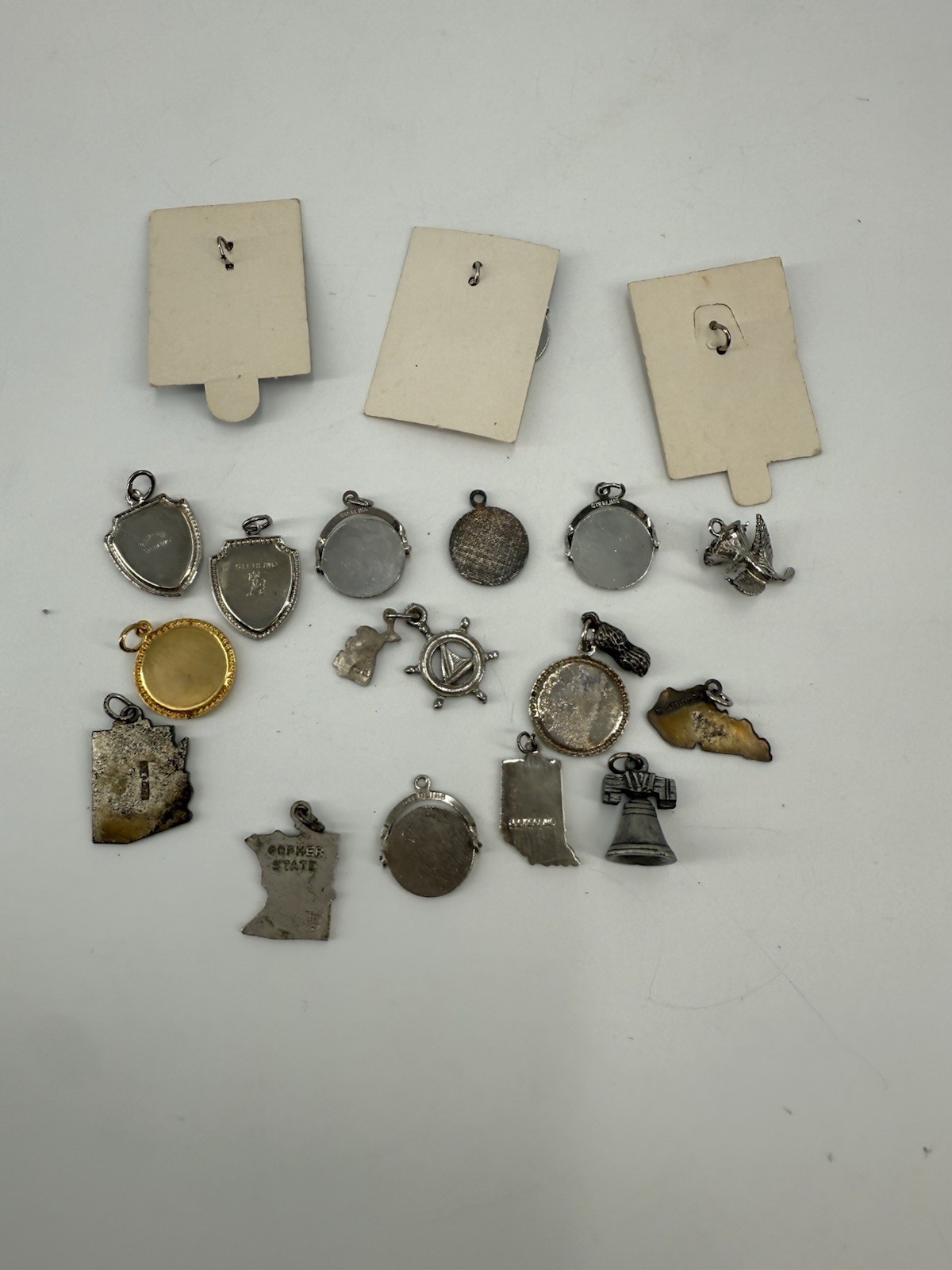 collection of vintage sterling silver souvenir charms from various locations
