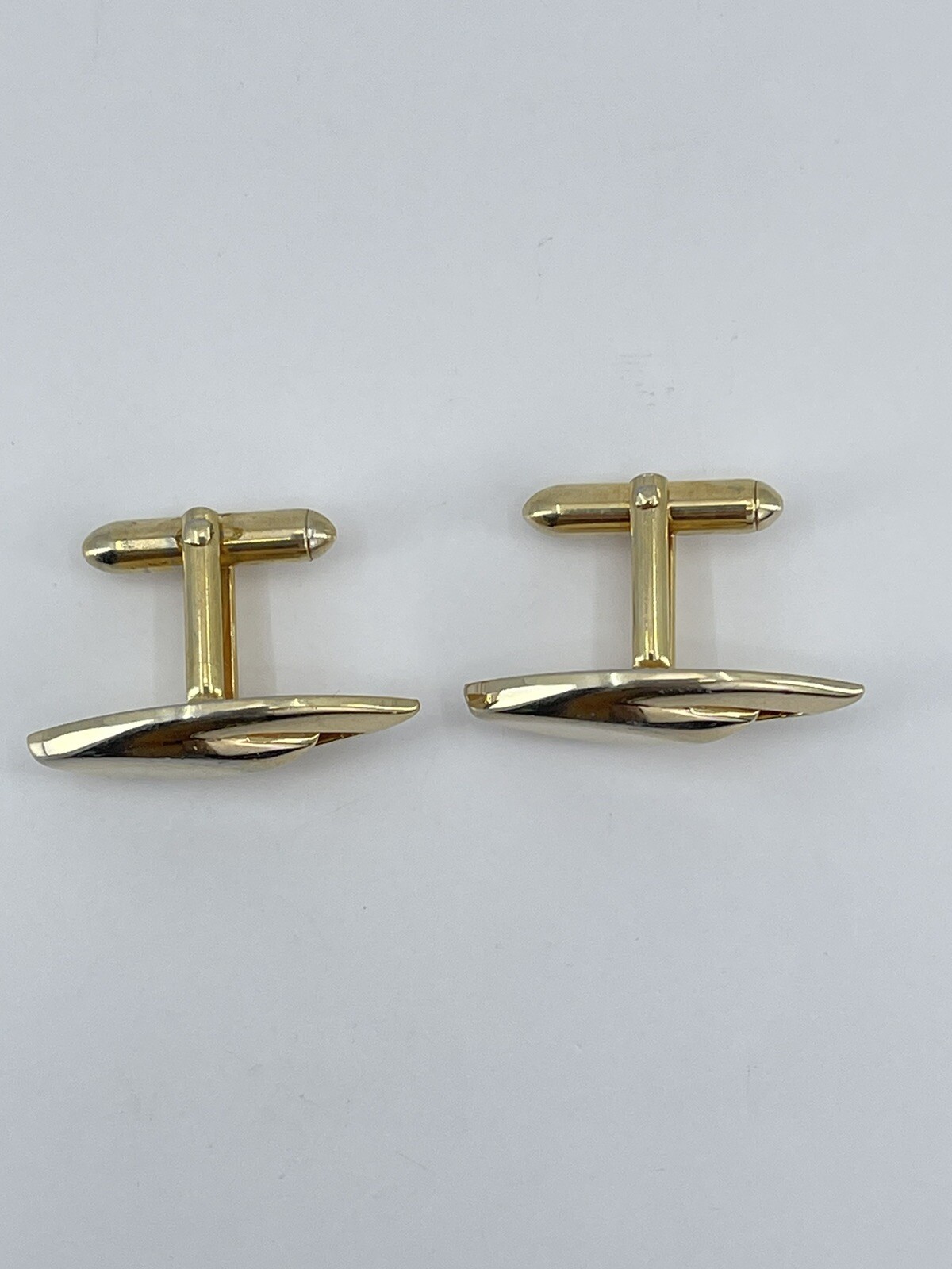 Vintage Swank mens cufflinks torpedo shaped raised cutout design gold tone 3/4″