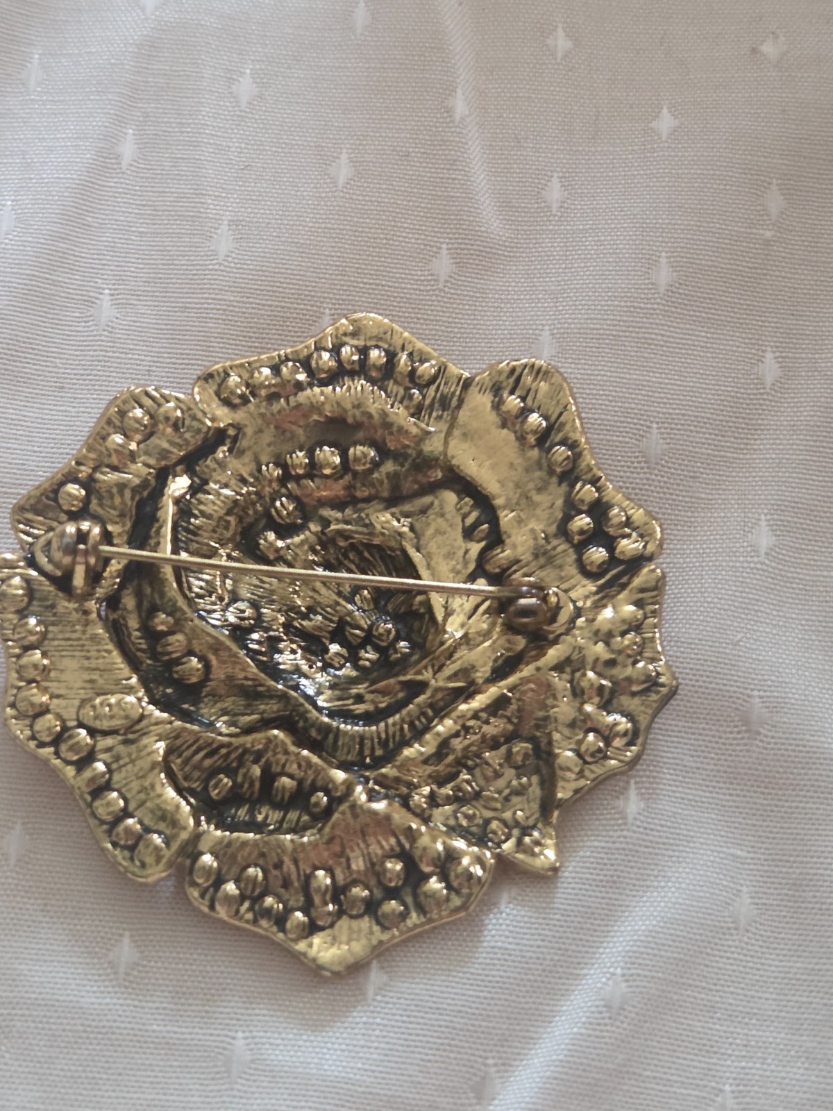 Heidi Daus “Ravishing Rose” brooch featuring red and iridescent crystals