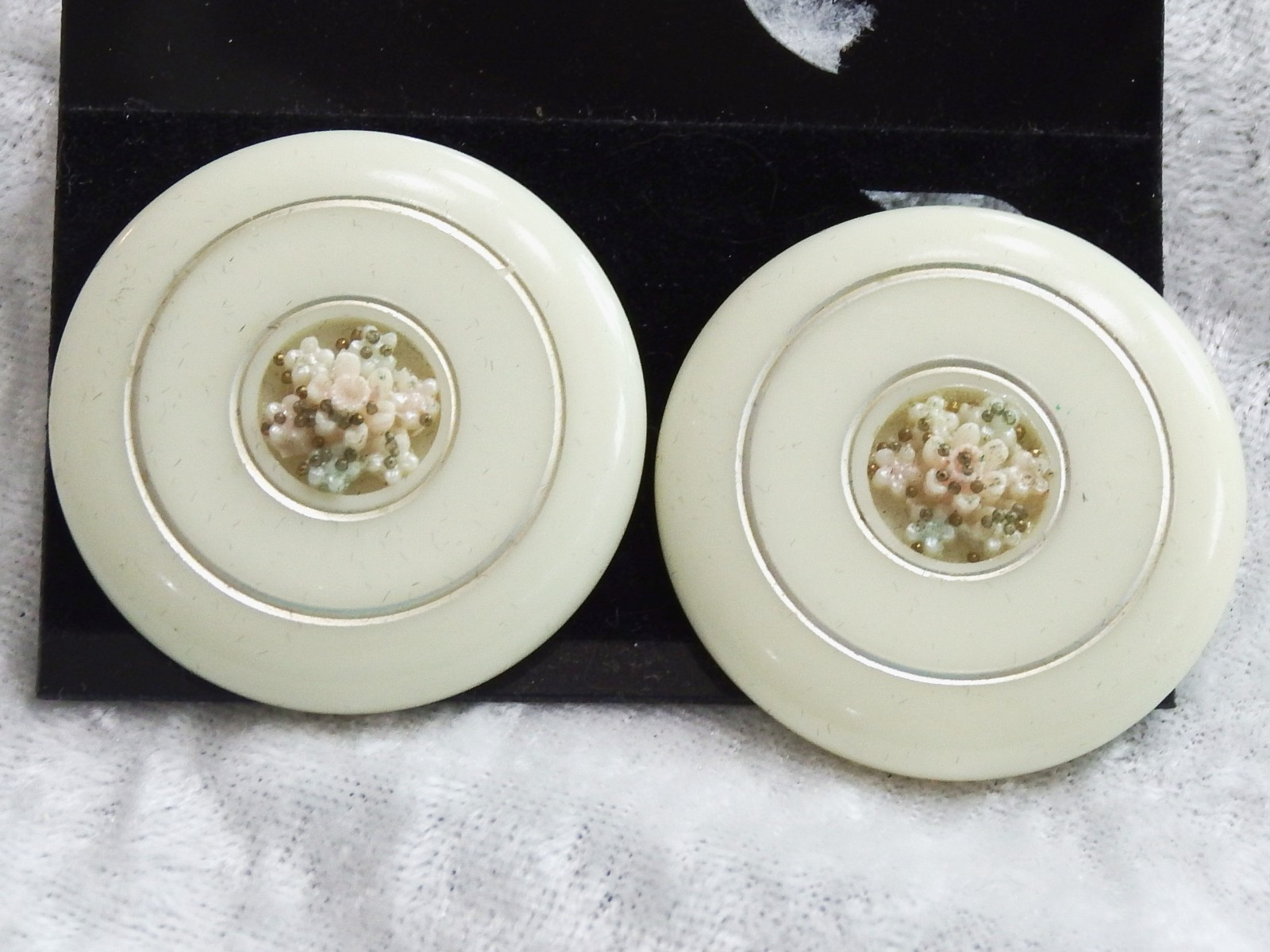 VINTAGE FLAT ROUND OFF WHITE CLIP BACK EARRINGS WITH FLORAL DESIGN