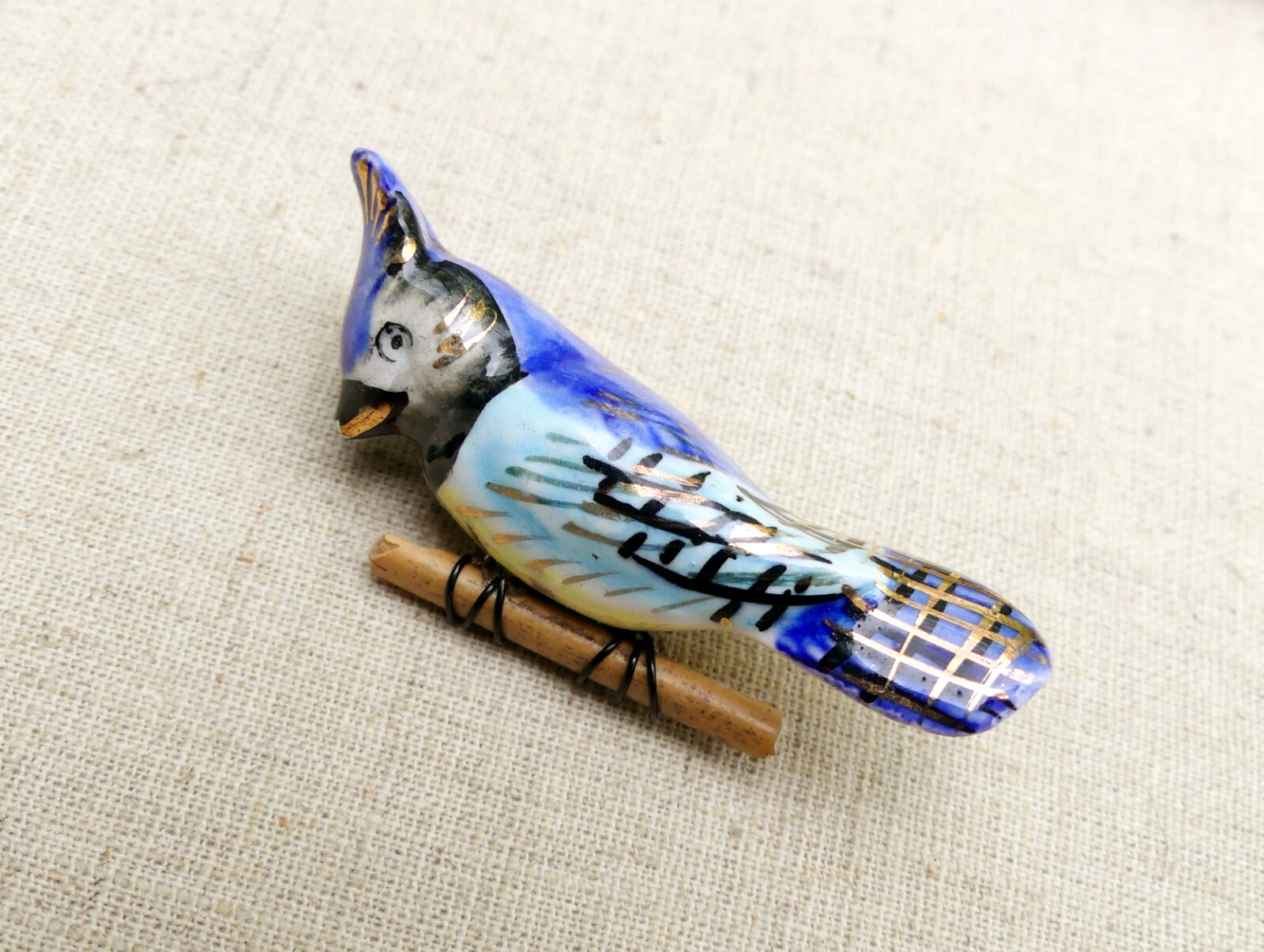 Vintage ceramic blue jay brooch on wood branch bird hand-painted gilt porcelain
