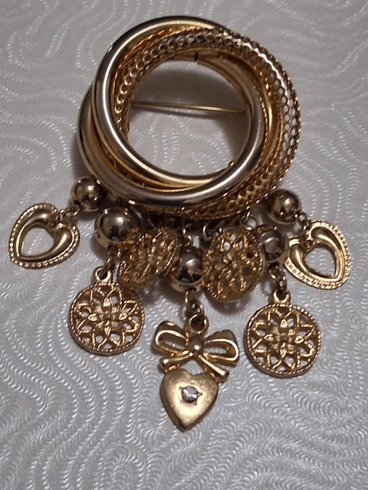 Interlocking circle charm brooch, gold-toned dangle drop charms