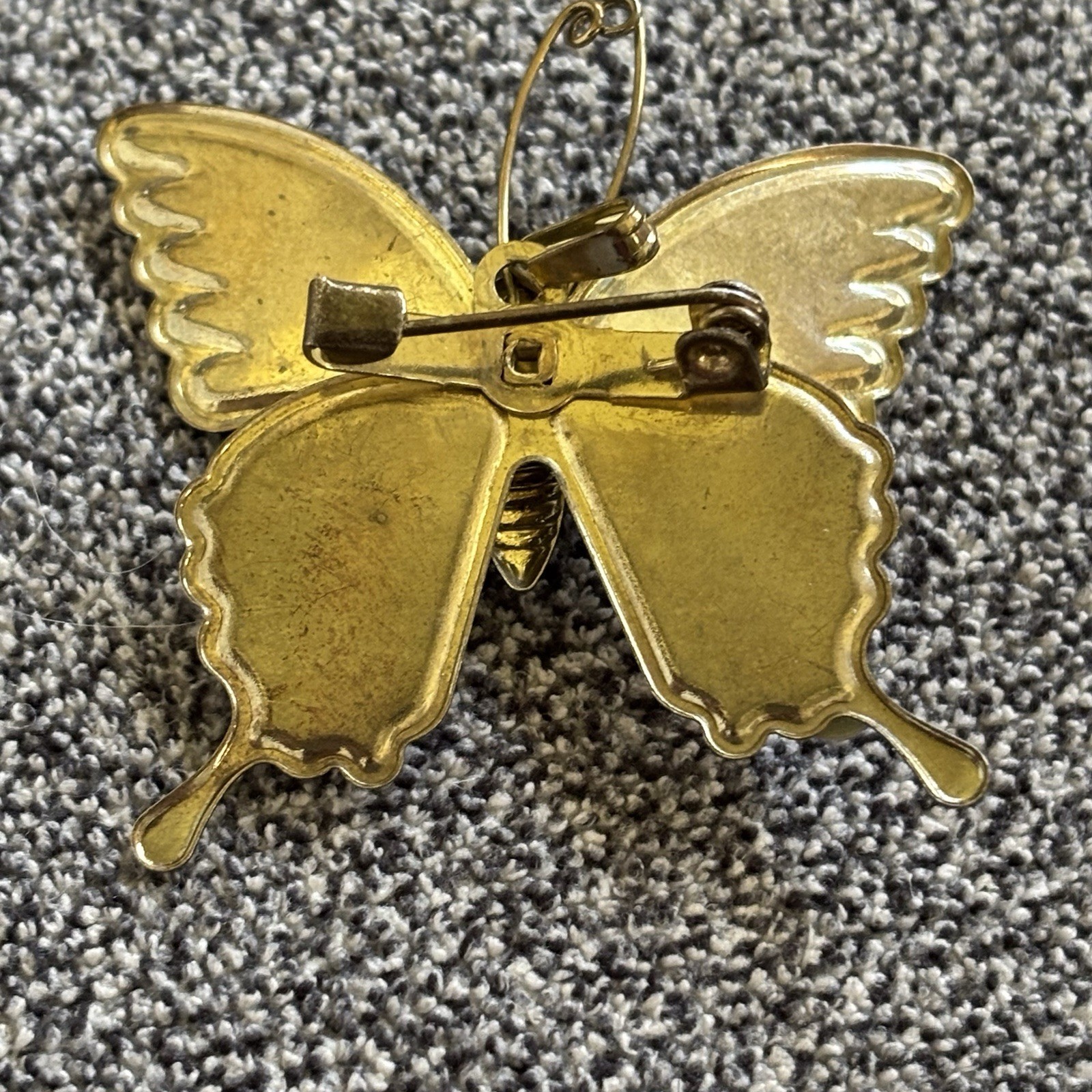 Butterfly Brooch or Pendant of Red Orange and Cream Resin on Gold Tone Setting.