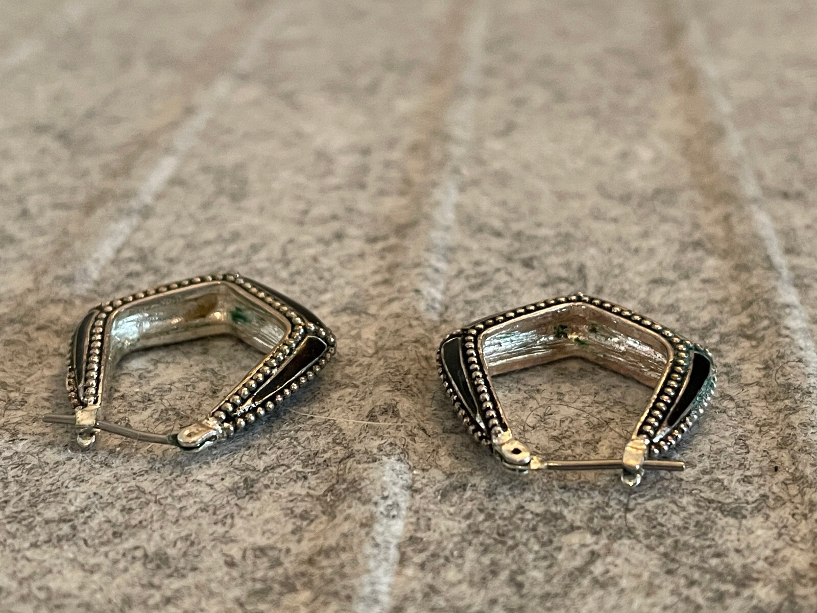 For auction is a Vintage MONET Silver Tone & Black Hoop Pierced Earring. Please