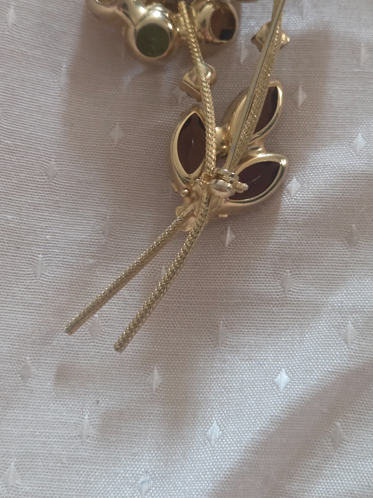 Juliana DeLizza & Elster floral brooch featuring green, amber, and yellow stones