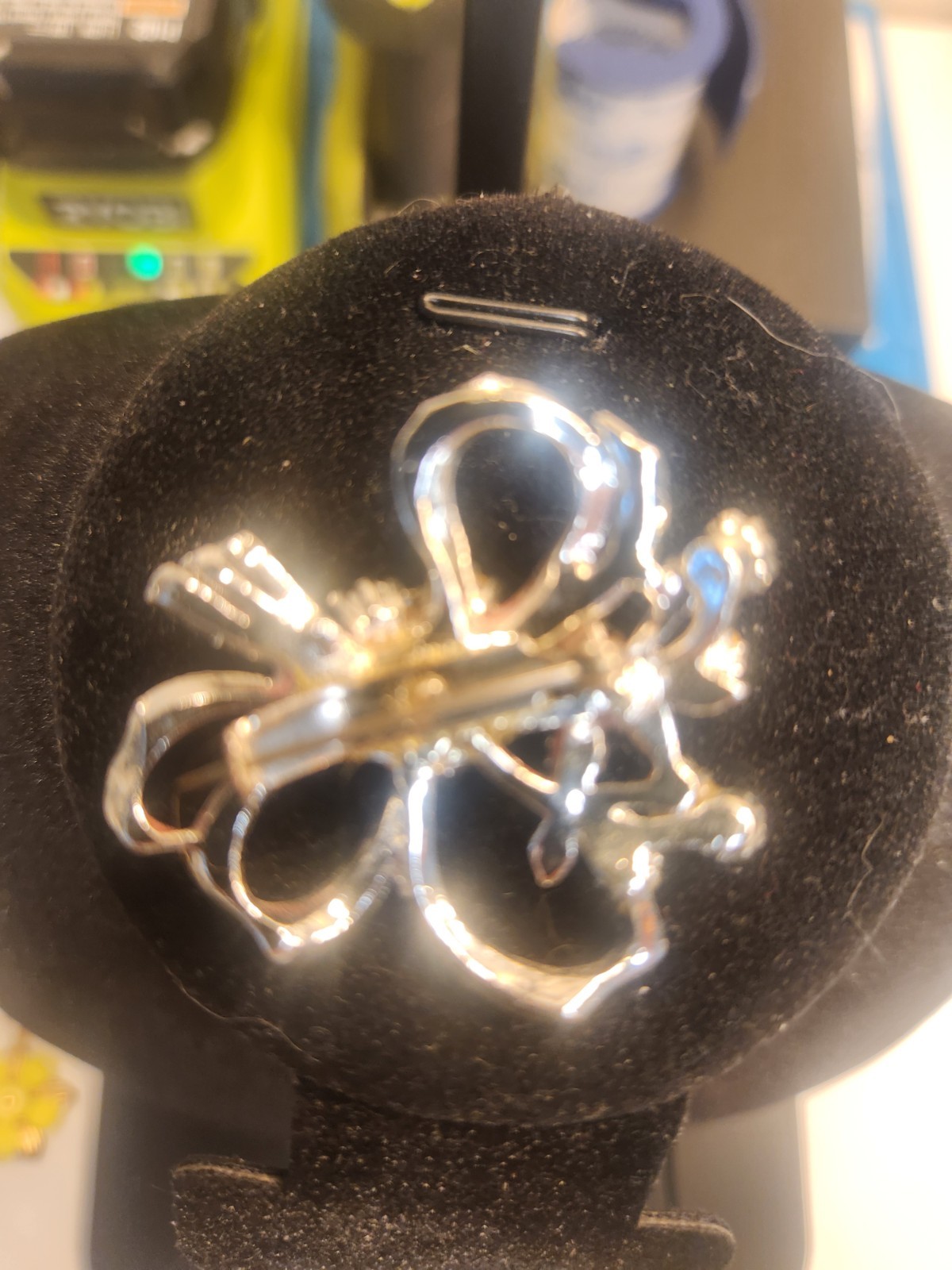 Rhinestone brooch featuring a silver-tone, ribbon bow and floral bouquet design