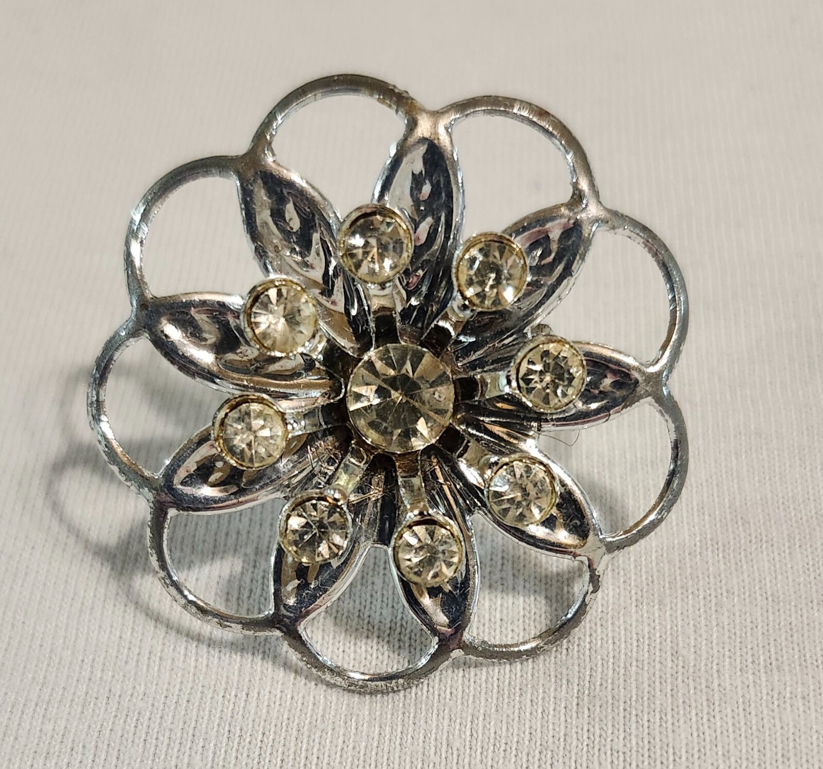 Silver Tone Brooch Flower Design with 8 Small Clear Stones and 1 Larger One