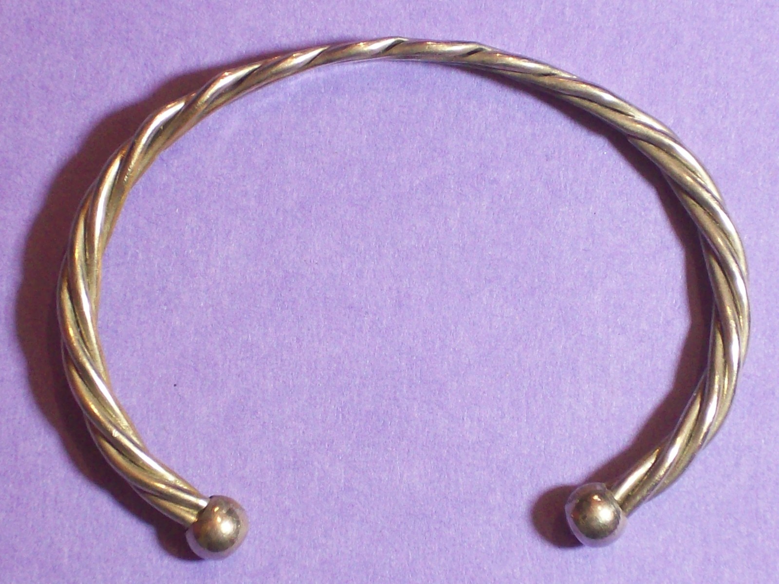 BRACELET ROPE STYLE SILVERY APPEARANCE 2 ¼” ACROSS INSIDE x 1 5/8” WIDE.