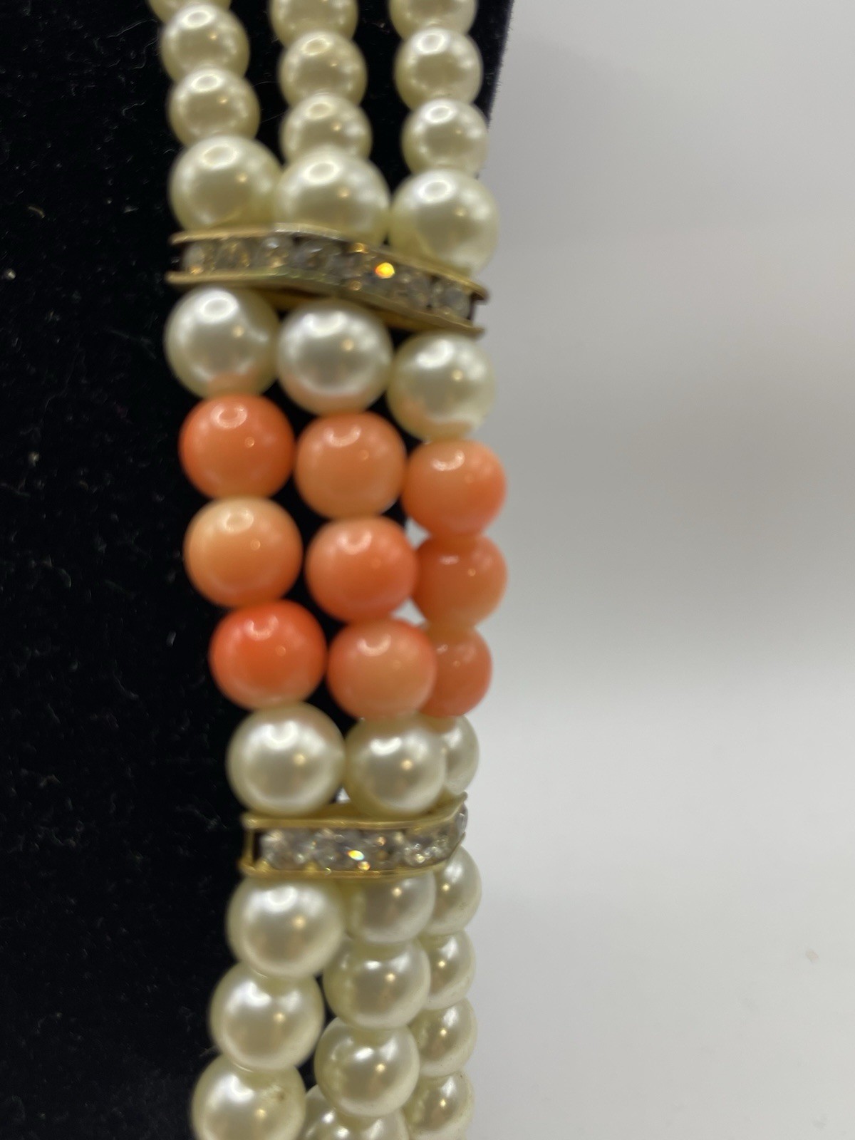 Vintage ivory and coral triple strand pearl necklace with gold tone clasp 20”