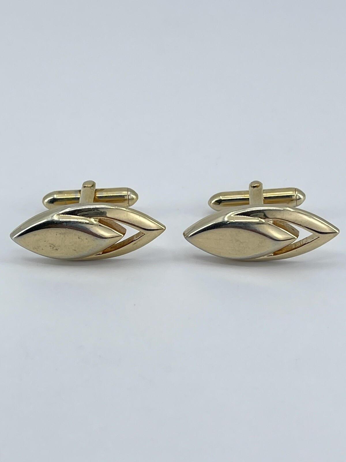 Vintage Swank mens cufflinks torpedo shaped raised cutout design gold tone 3/4″