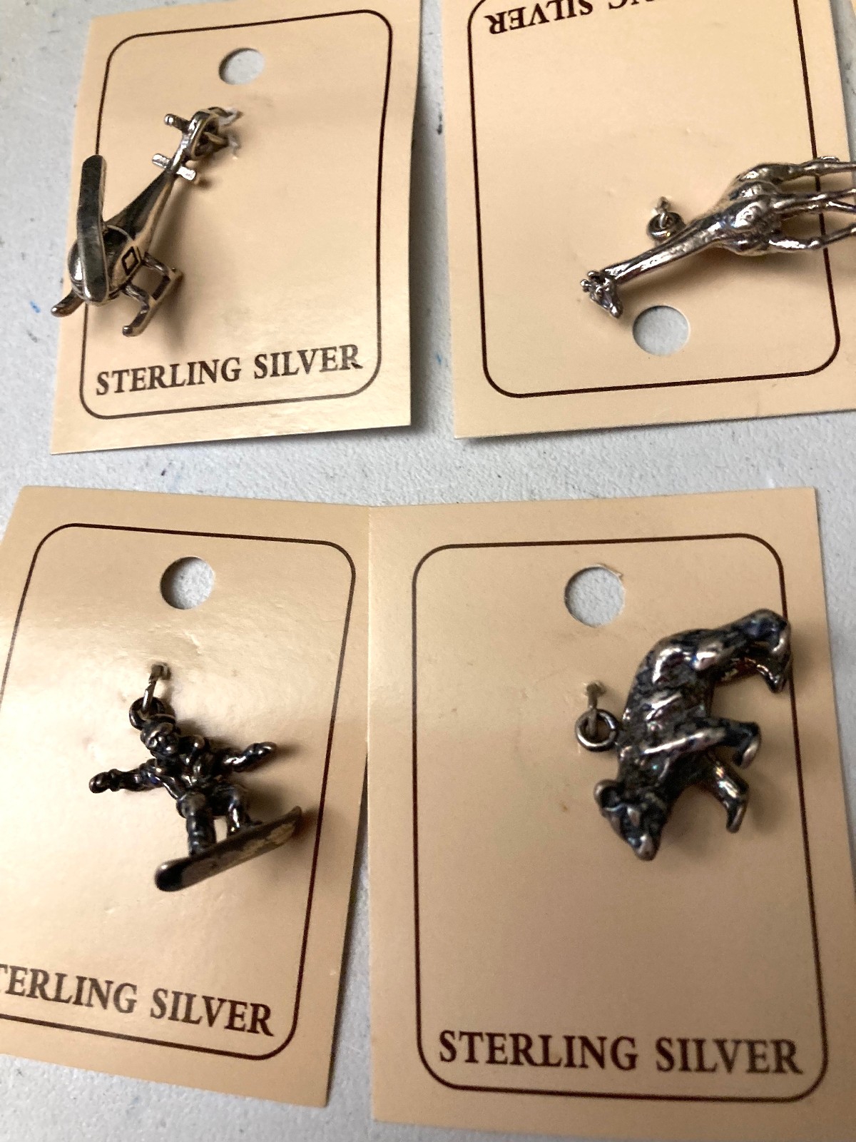 VINTAGE (10 ) DIFFERENT STERLING .925 CHARMS STILL ON CARDS N.O.S.